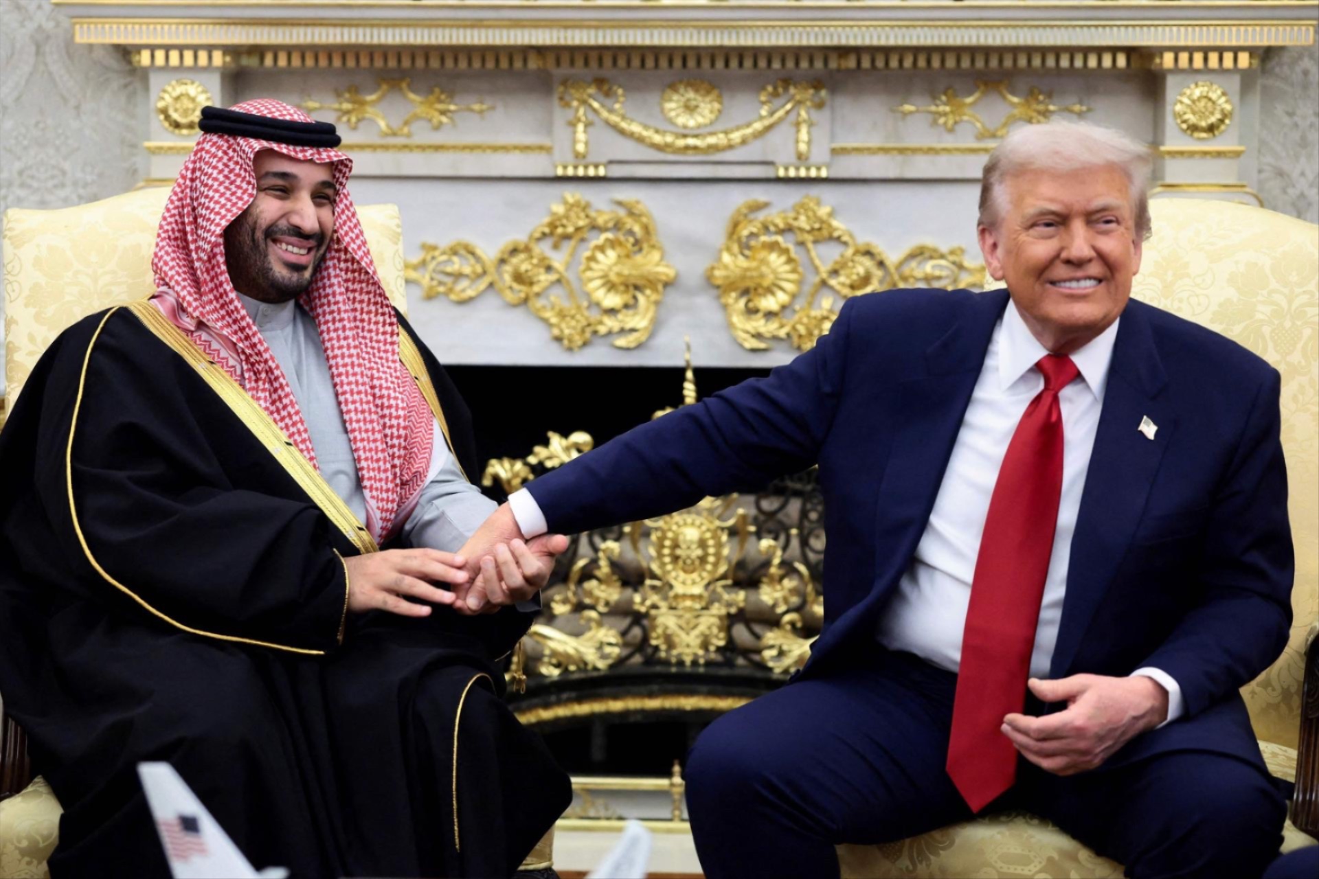 Saudi Crown Prince Mohammed bin Salman holds U.S. President Donald Trump’s hand during a meeting at the White House in Washington, DC, November 18, 2025. 