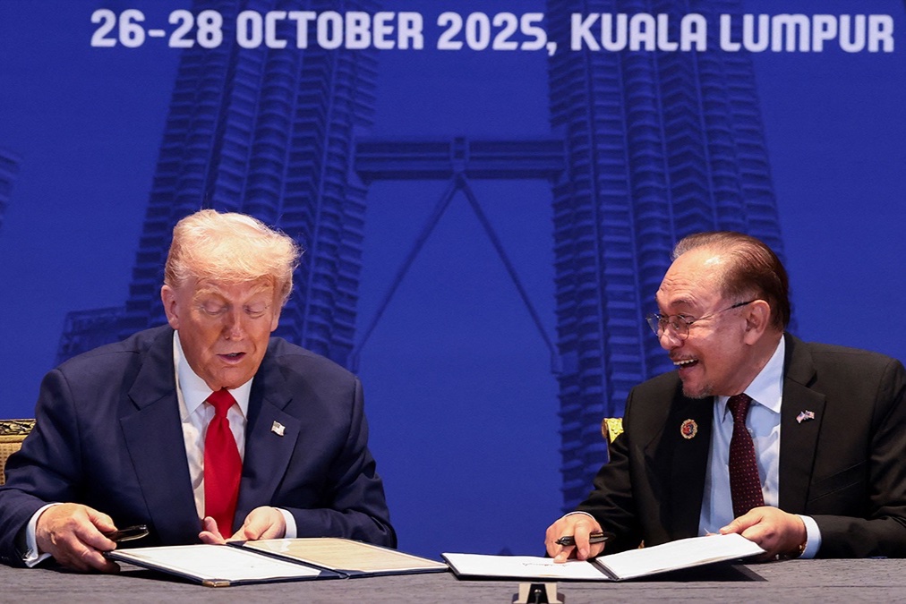 President Donald Trump and Malaysian Prime Minister Anwar Ibrahim sign trade deal documents during a bilateral meeting during the 47th Association of Southeast Asian Nations (ASEAN) summit in Kuala Lumpur, Malaysia, October 26, 2025. 