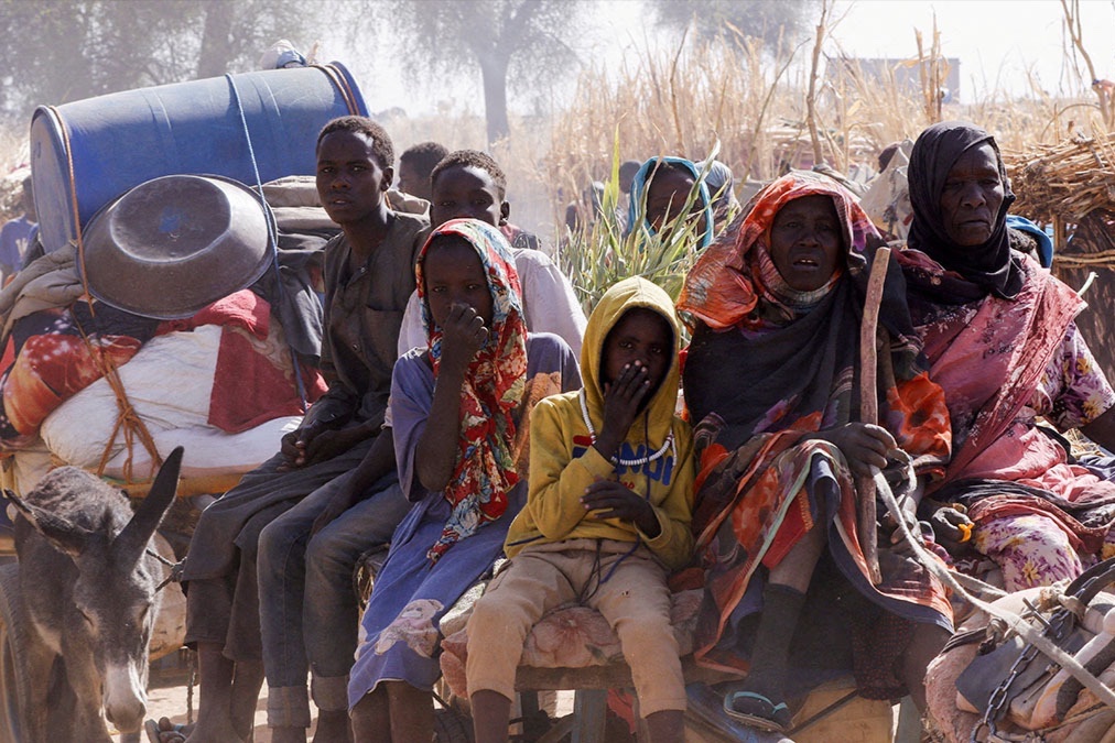 Displaced people ride an animal-drawn cart, following attacks on the Zamzam displacement camp, in the town of Tawila in Sudan on April 15, 2025. 