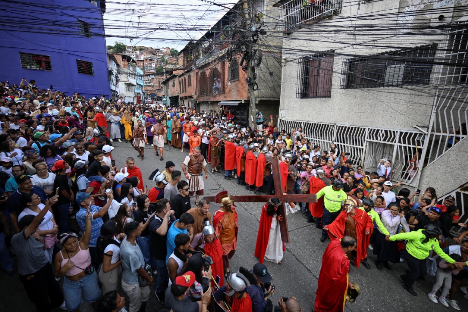 People watch a reenactment of the crucifixion of Jesus Christ during the Good Friday procession in the Petare neighborhood of Caracas, Venezuela, April 3, 2026. 