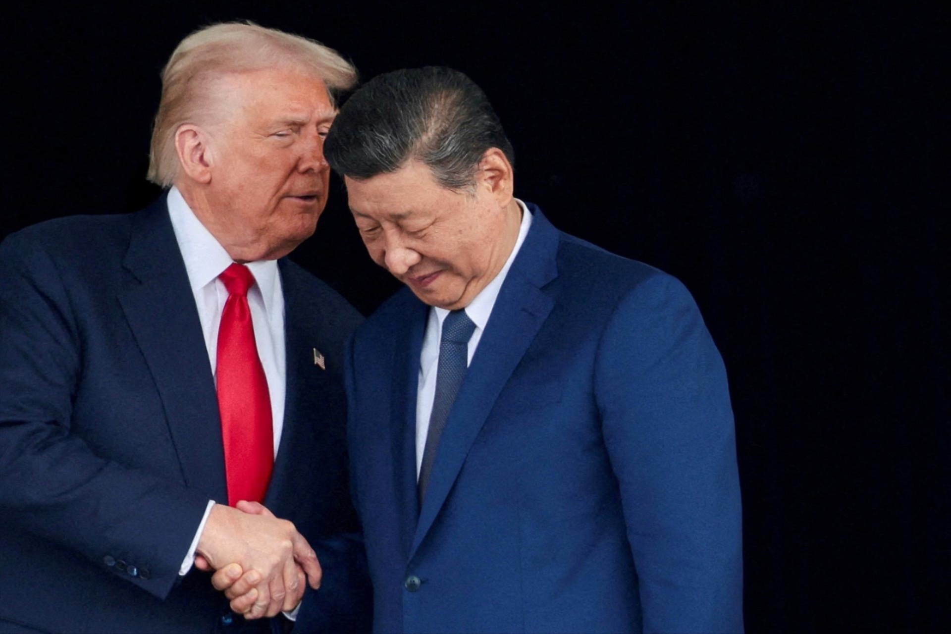 President Donald Trump and Chinese President Xi Jinping talk as they leave a bilateral meeting at Gimhae International Airport, in Busan, South Korea, October 30, 2025. 