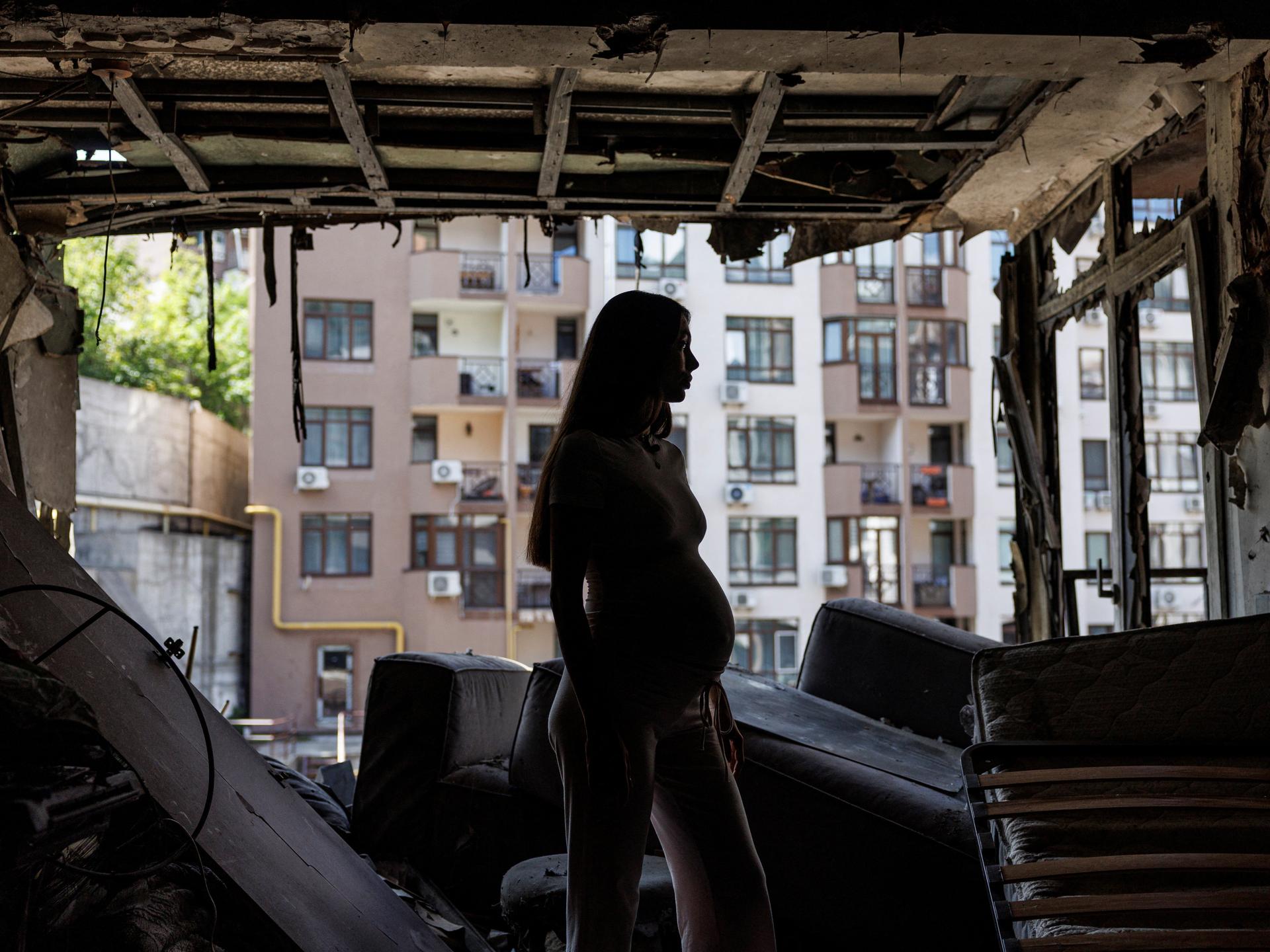 Bohdana Zhupanyna, a 30-year-old mother-to-be, stands inside her apartment that was damaged by a Russian drone strike, in Kyiv, Ukraine, on July 23, 2025.