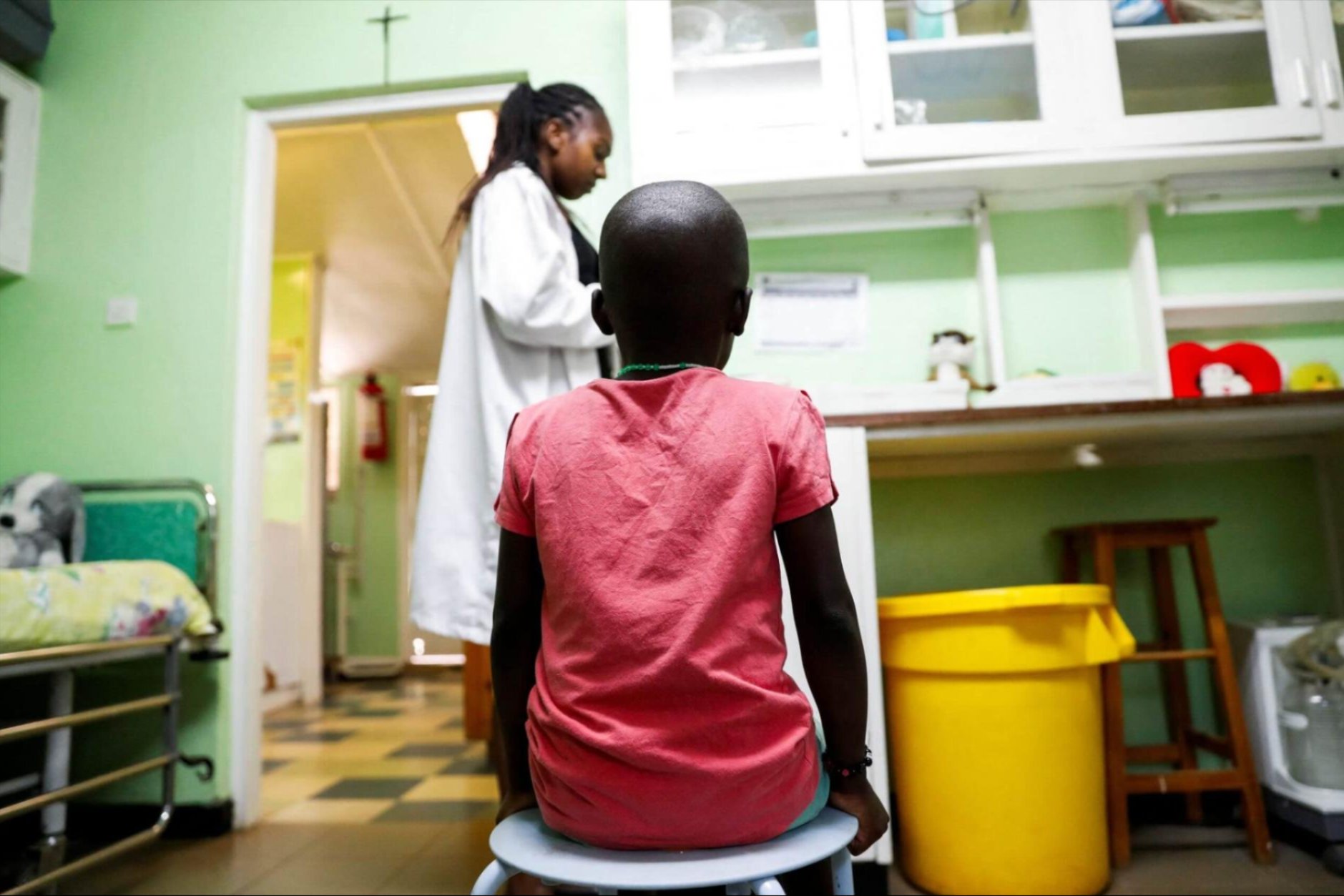 A child sits as a nurse prepares to dispense antiretroviral drugs used to prevent HIV from replicating, at the Nyumbani Children's Home, in Nairobi, Kenya, on February 12, 2025.