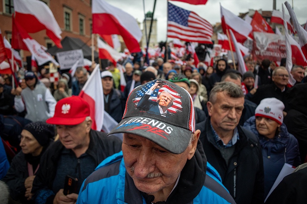 A man wears a cap with a picture of Donald Trump at an anti-immigration demonstration in Warsaw, Poland.