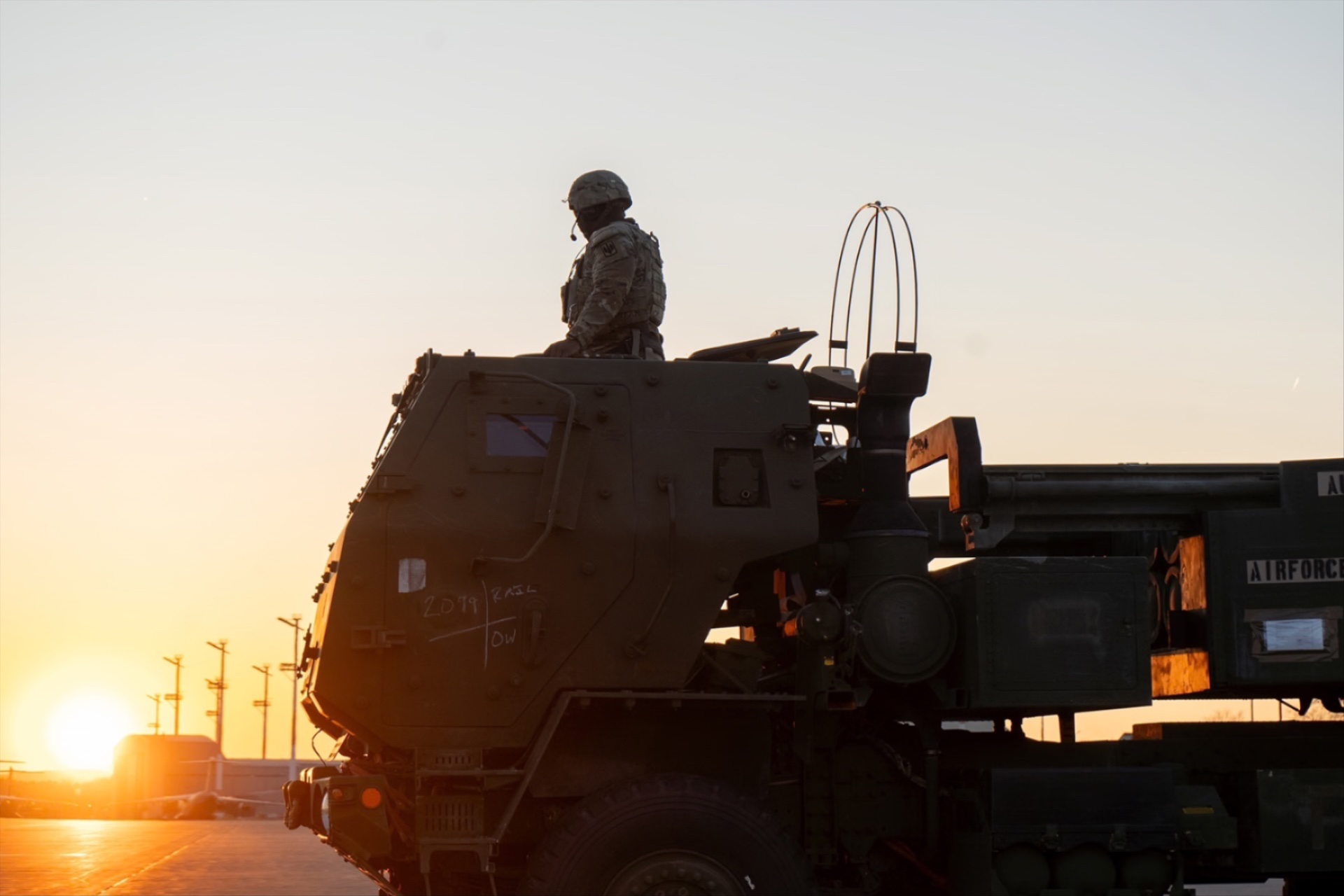 U.S. Army Staff Sgt. Zykee Allen, assigned to 3rd Battalion, 321st Field Artillery Regiment, sits atop an M142 High Mobility Artillery Rocket System (HIMARS) to receive a fire mission during a training mission at Ramstein Air Base, Germany, on March 27, 2025. 