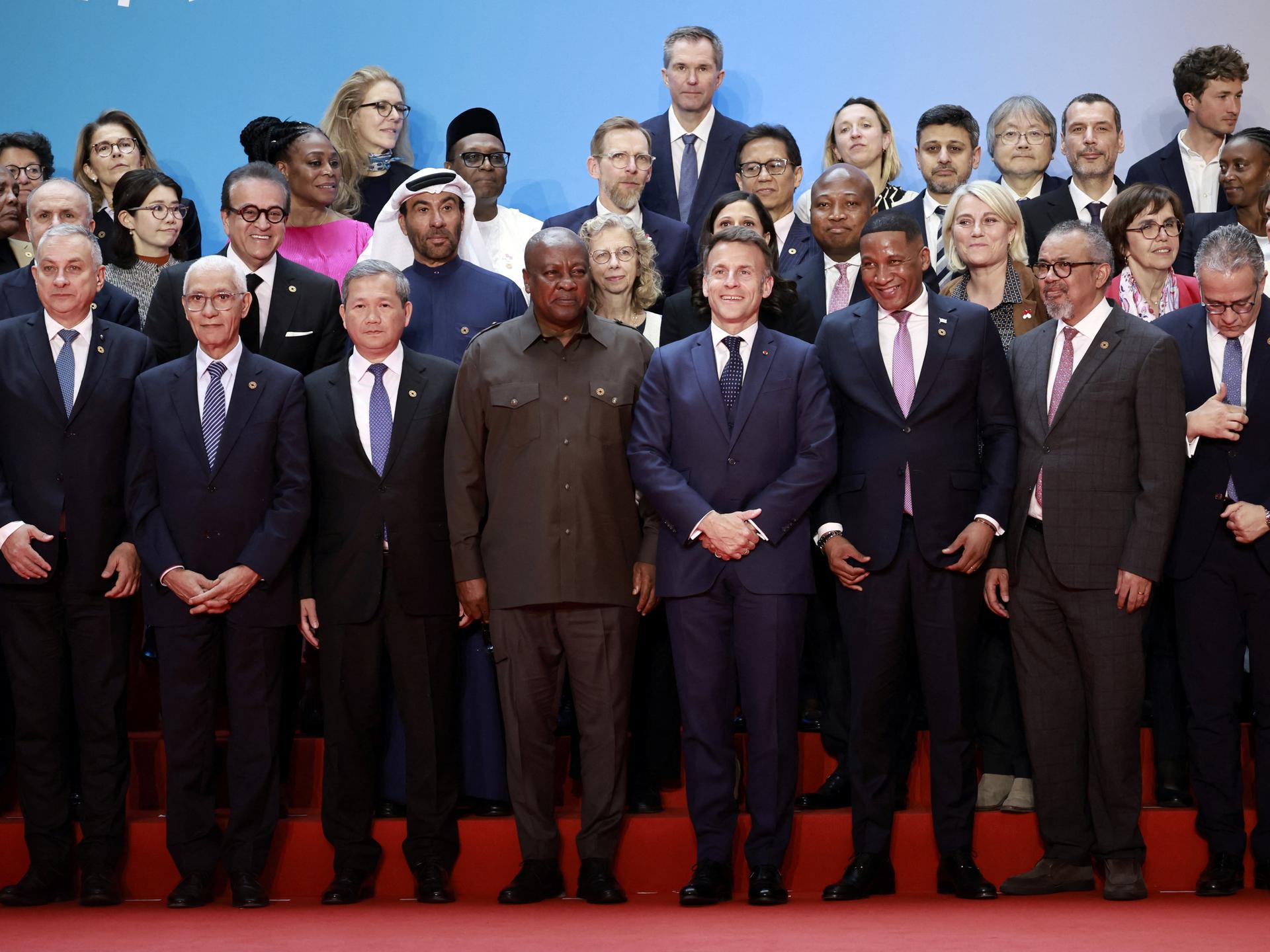 A father and son, working to reclaim what remains of a home reduced to ash, douse smoldering earth with water after a fire tore through their section of the encampment, in Cox's Bazar, Bangladesh, on December 24, 2024. 