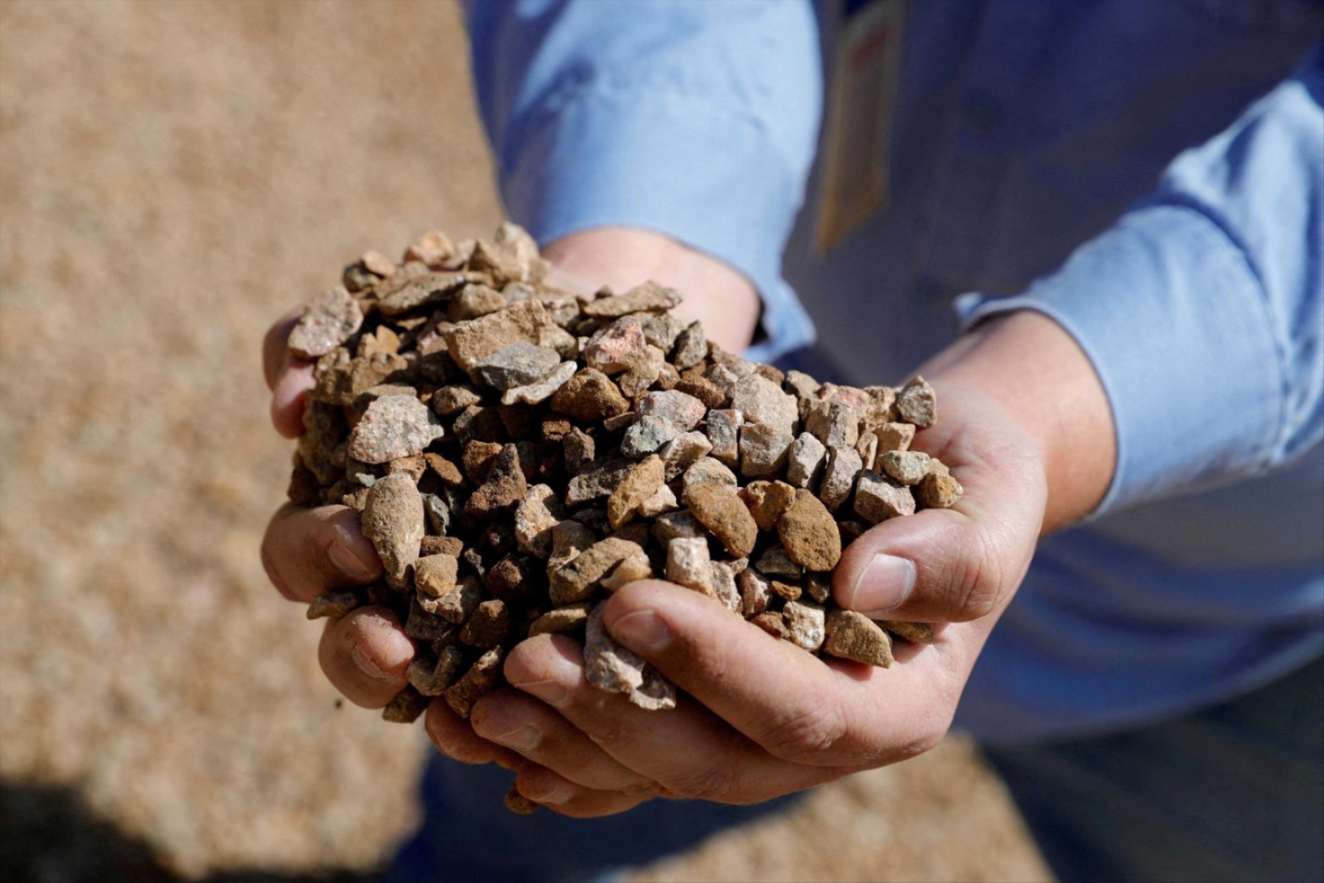 A mining/crushing supervisor at MP Materials displays crushed ore before it is sent to the mill at the MP Materials rare earth mine in Mountain Pass, California, U.S. January 30, 2020.