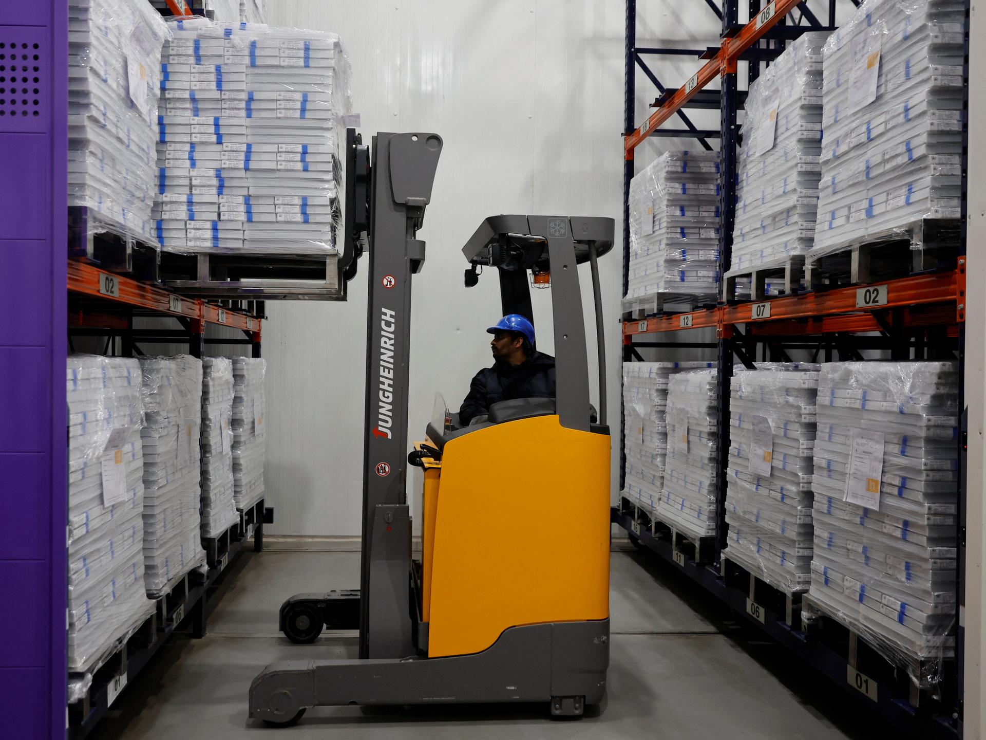 A forklift unloads boxes containing vials of the R21 malaria vaccine, inside a cold room, at the Serum Institute of India, in Pune, India, on February 27, 2024.