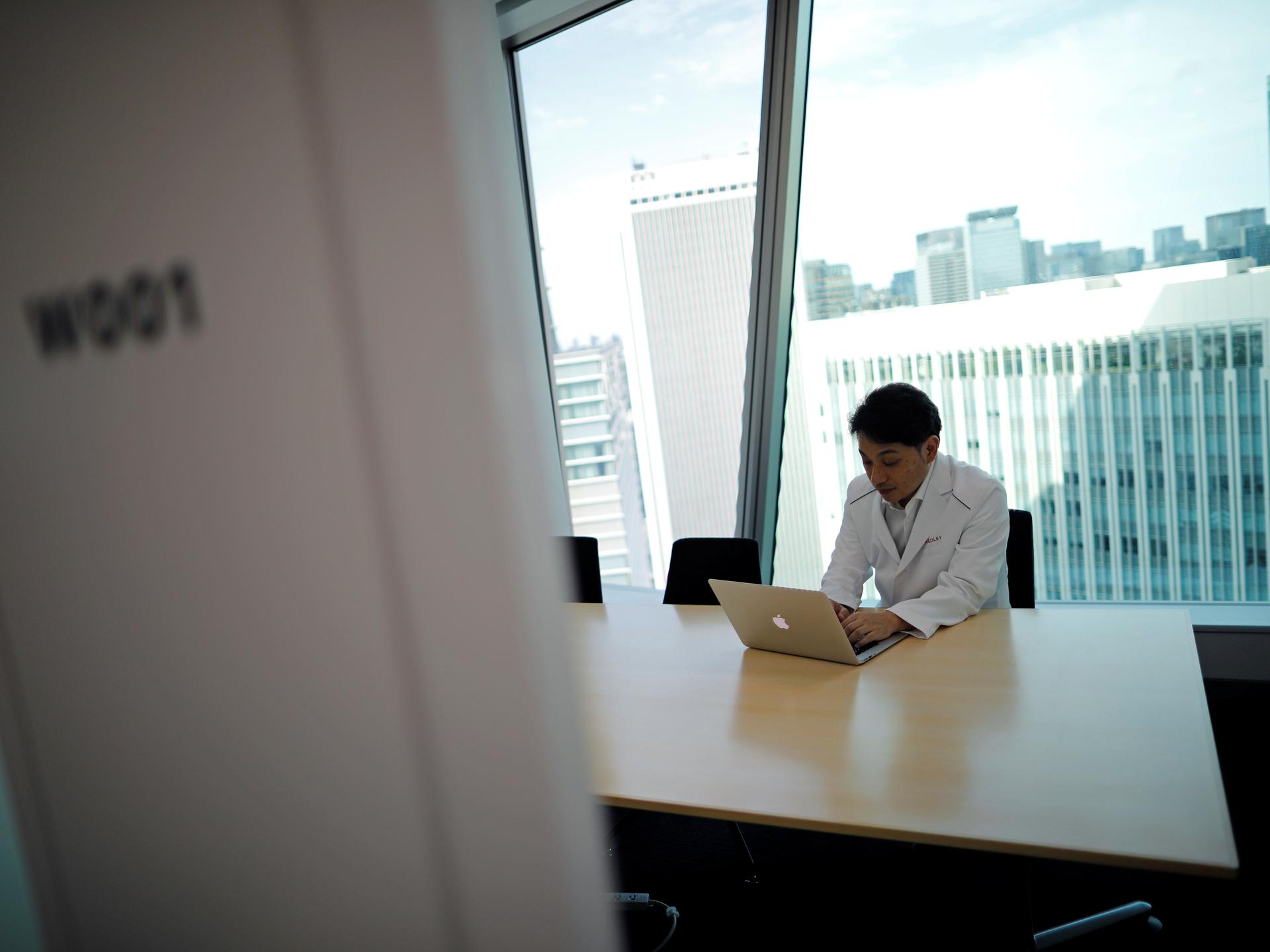 Makoto Kitada, MD, demonstrates a telemedicine application service called 'CLINICS,' in Tokyo, Japan, on July 8, 2020.