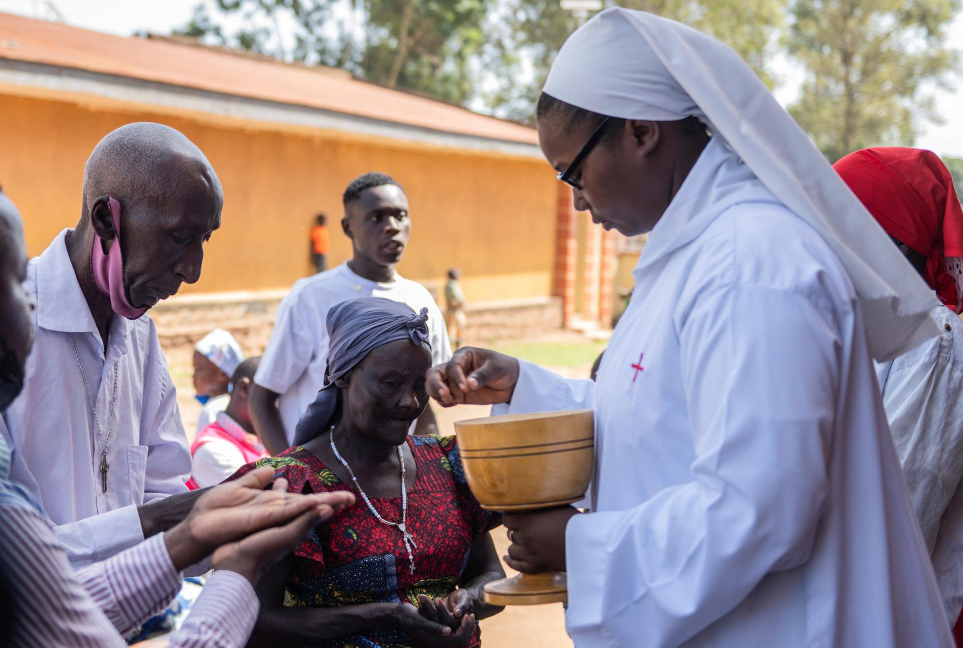 Catholic nuns serve worshippers with the Holy Eucharist during the Sunday Mass at The Notre Dame de Graces Cathedral (Cathedral of Our Lady of Graces), amid a resurgence of Ebola involving the Bundibugyo strain, a rarer variant of the virus with no approved vaccine currently available, in the Mudzi-Maria neighborhood of Bunia, Ituri province, in the Democratic Republic of Congo on May 24, 2026.