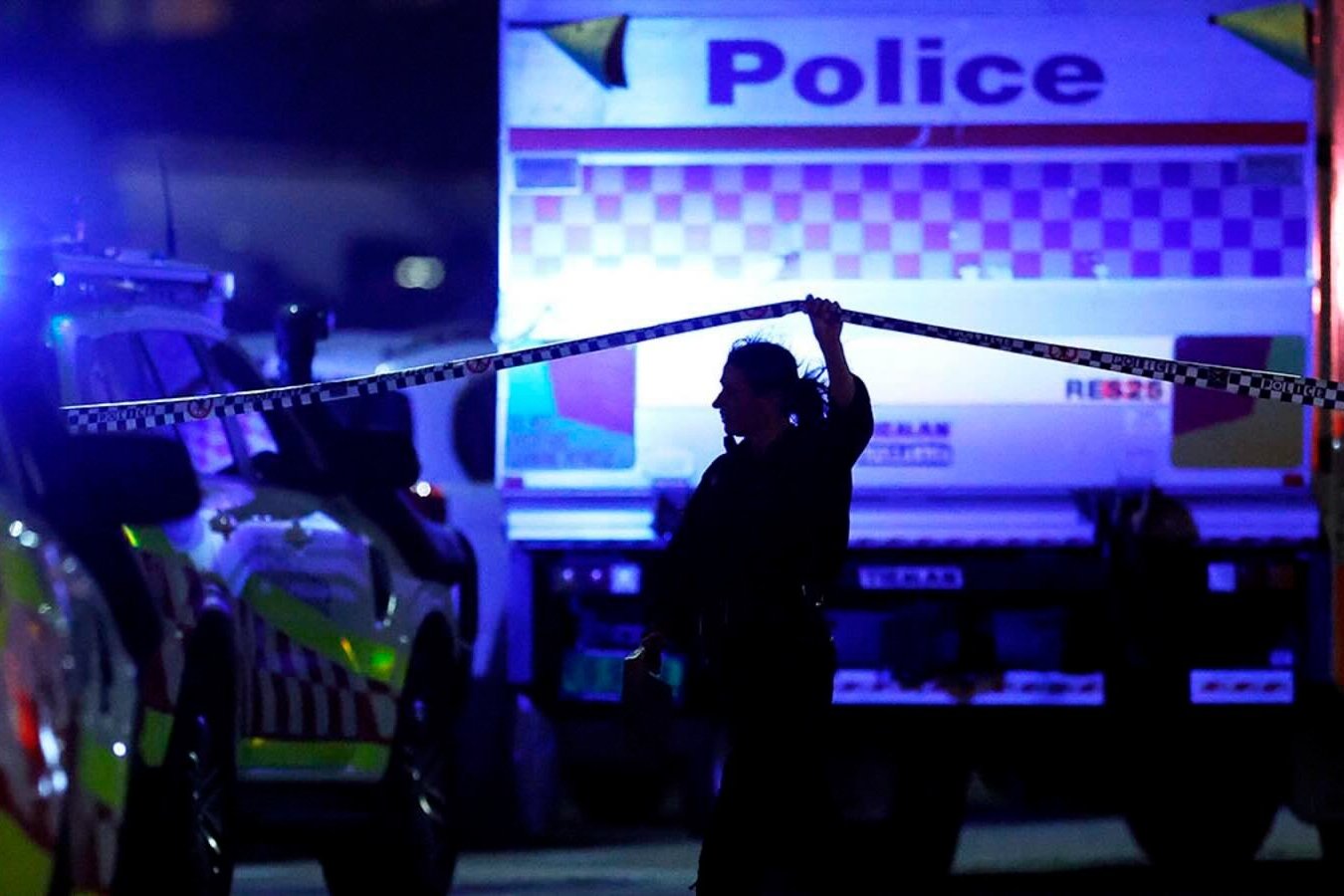 A police officer walks along cordon tapeline at the scene of a mass shooting at Bondi Beach in Sydney, Australia on December 14, 2025.