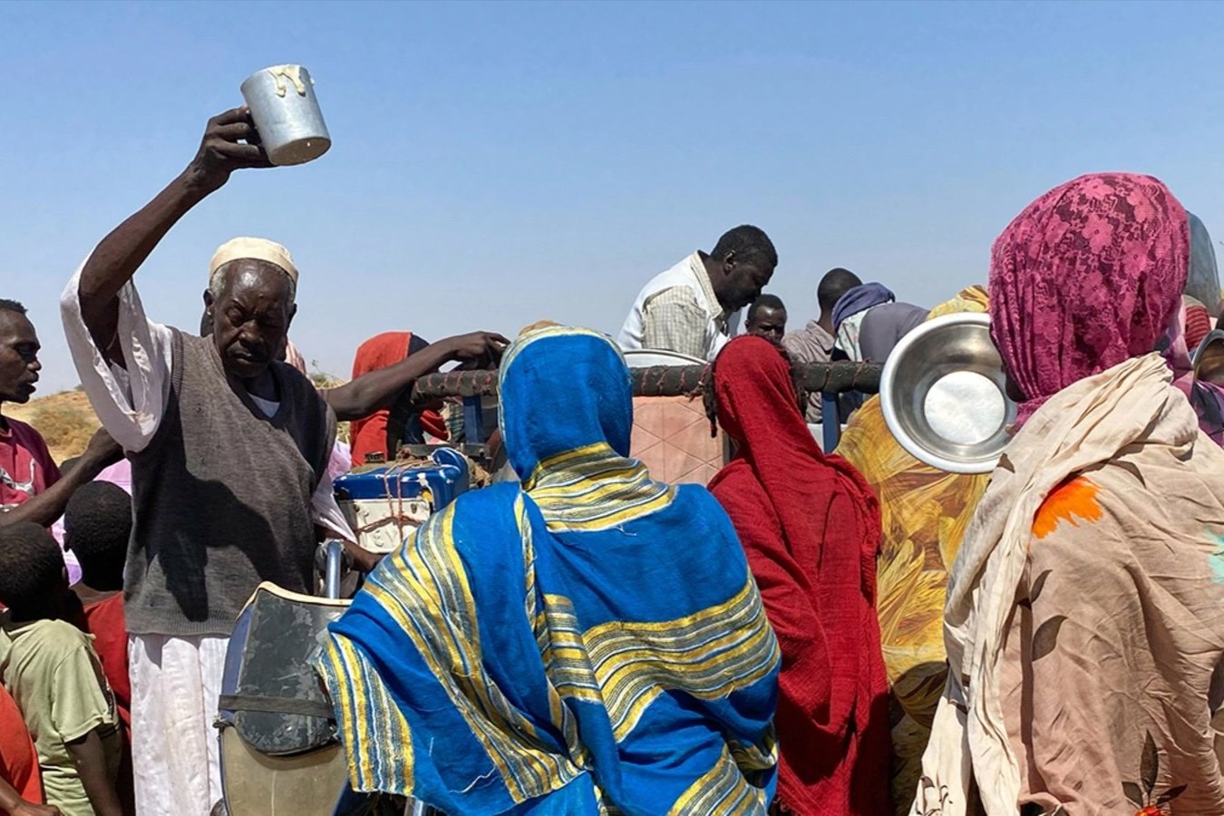 Sudanese who fled El Fasher after paramilitary forces killed hundreds of people in the western Darfur region, crowd to receive food at their camp in Tawila, Sudan, Sunday, Nov. 2, 2025.
