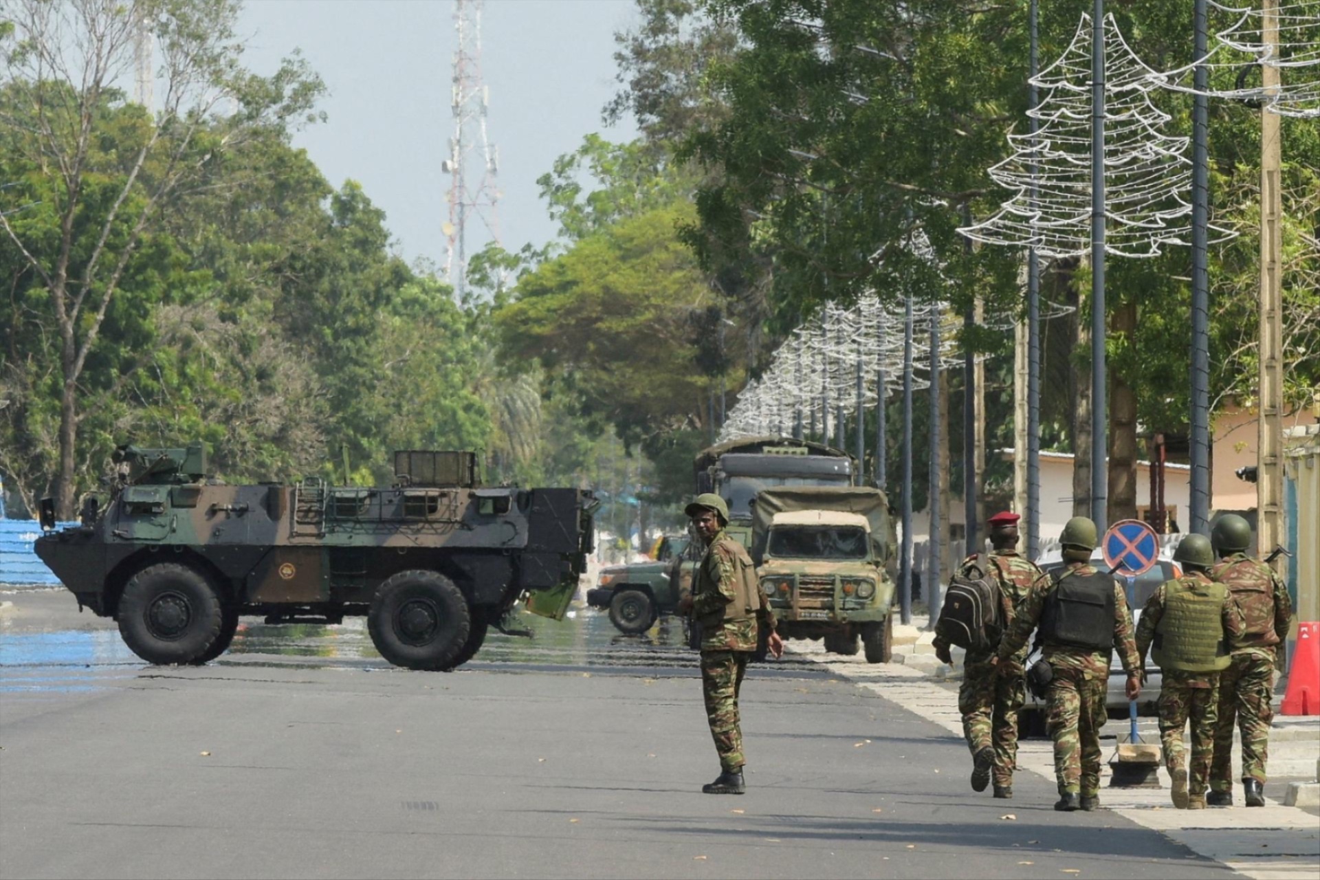 Soldiers patrol in front of Benin's radio and television station after, according to Benin's Interior Minister, the country's armed forces thwarted the attempted coup against Beninese President Patrice Talon, in Cotonou, Benin, on December 7, 2025.
