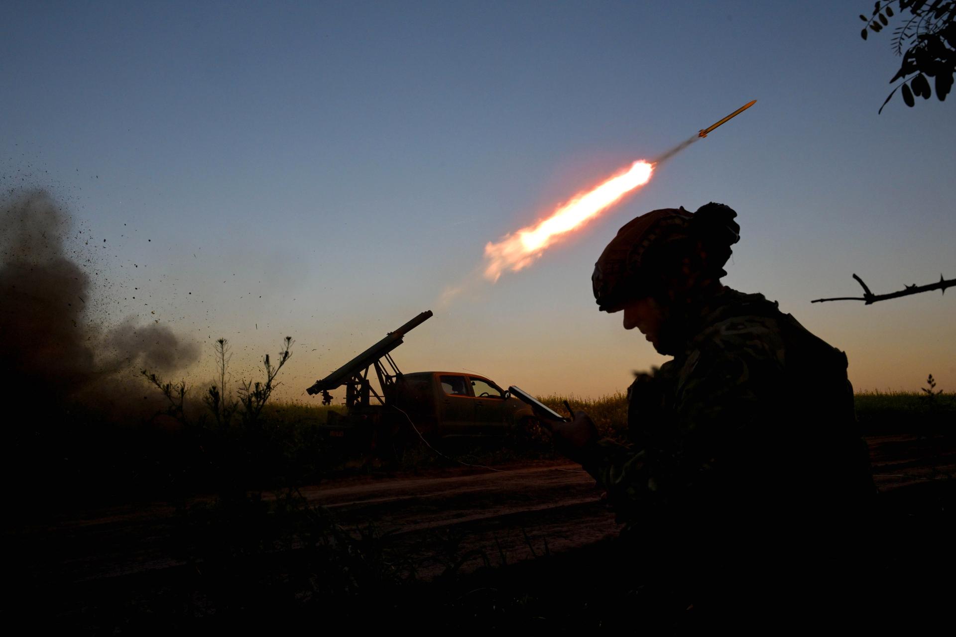 A silhouette of a Ukrainian soldier in front of a just-launched missile. 