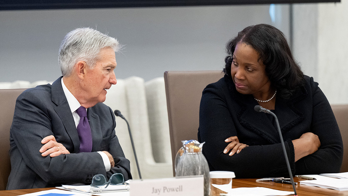 Federal Reserve Chair Jerome Powell speaks with Fed Governor Lisa Cook during a board meeting, June 25, 2025.