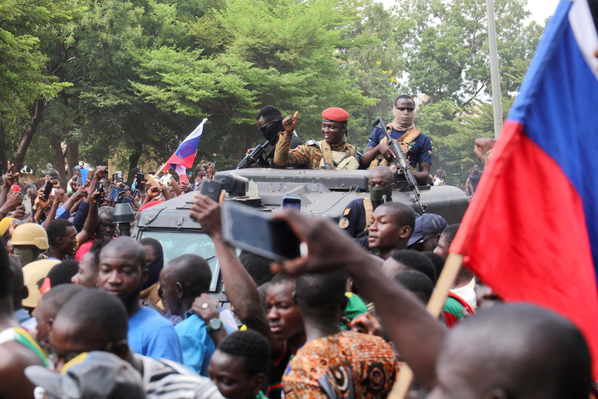 Burkina Faso’s self-declared leader Ibrahim Traore is surrounded by supporters holding Russian flags in Ouagadougou, Burkina Faso, on October 2, 2022.