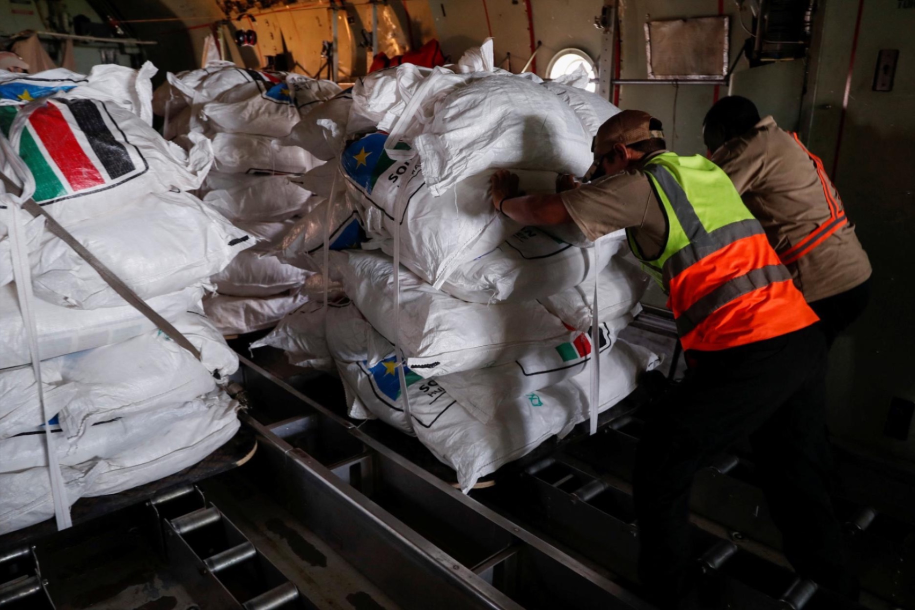 Workers load food aid in a cargo plane at Juba International airport in South Sudan, June 9, 2025.