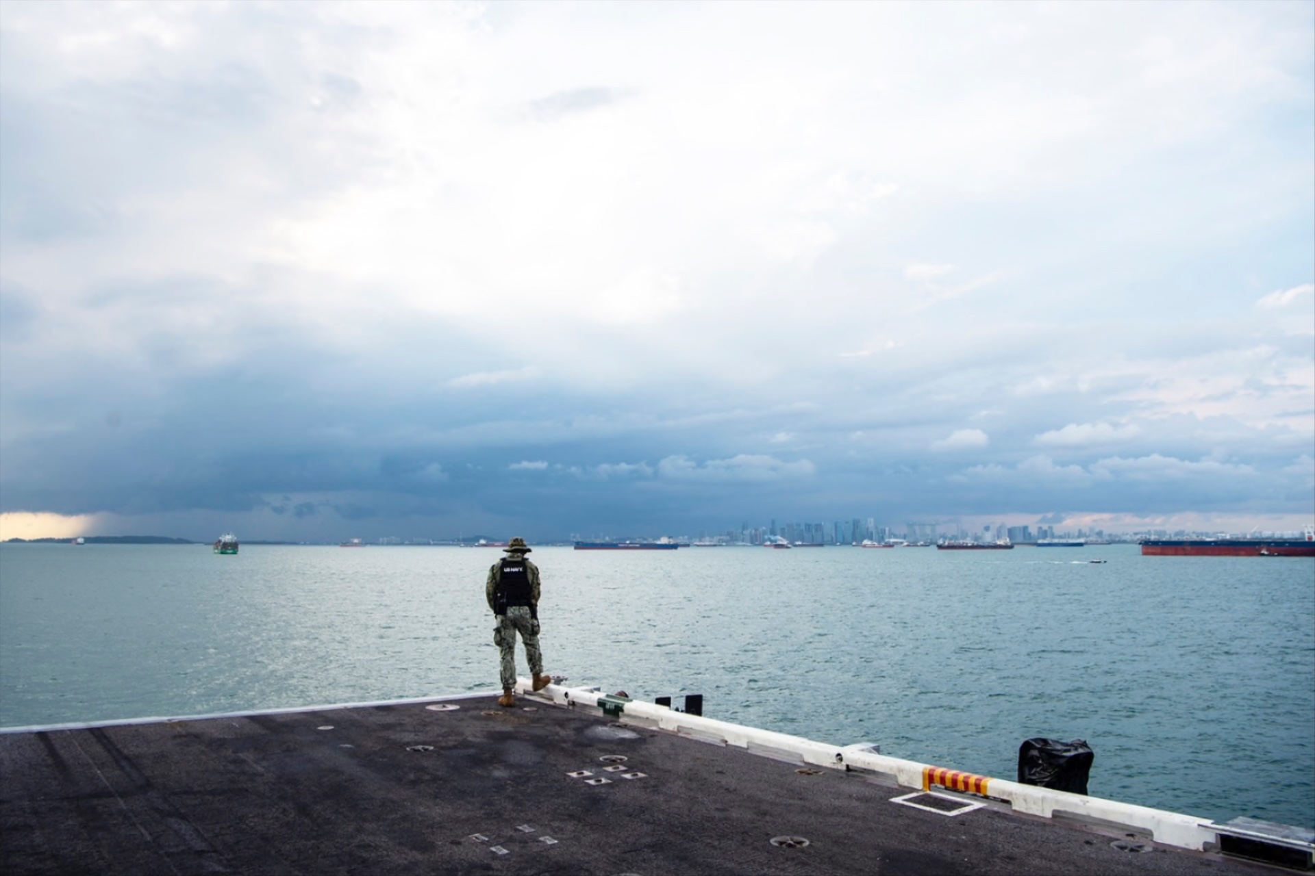 Master-at-Arms third Class Elisha Francois stands watch as the Nimitz-class aircraft carrier transits the Strait of Malacca, December 28, 2024. 