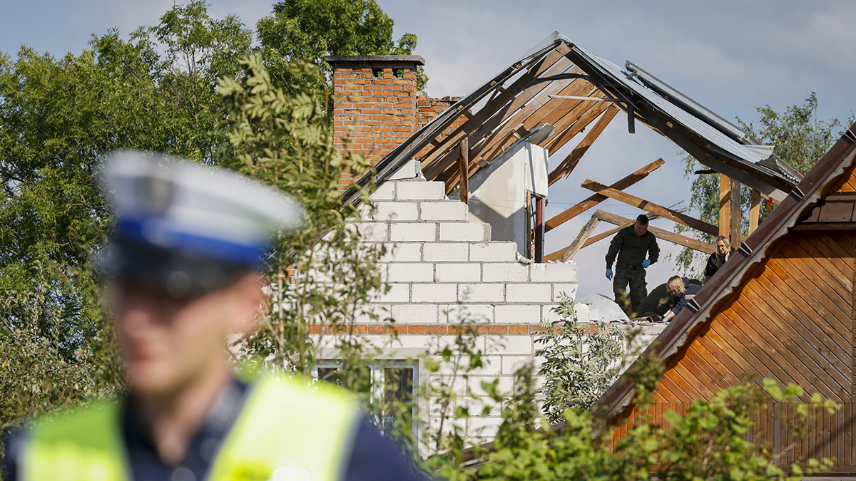 Members of the police and the army inspect damage to a house destroyed by debris from a Russian drone in the village of Wyryki-Wola, Poland, September 10, 2025. 