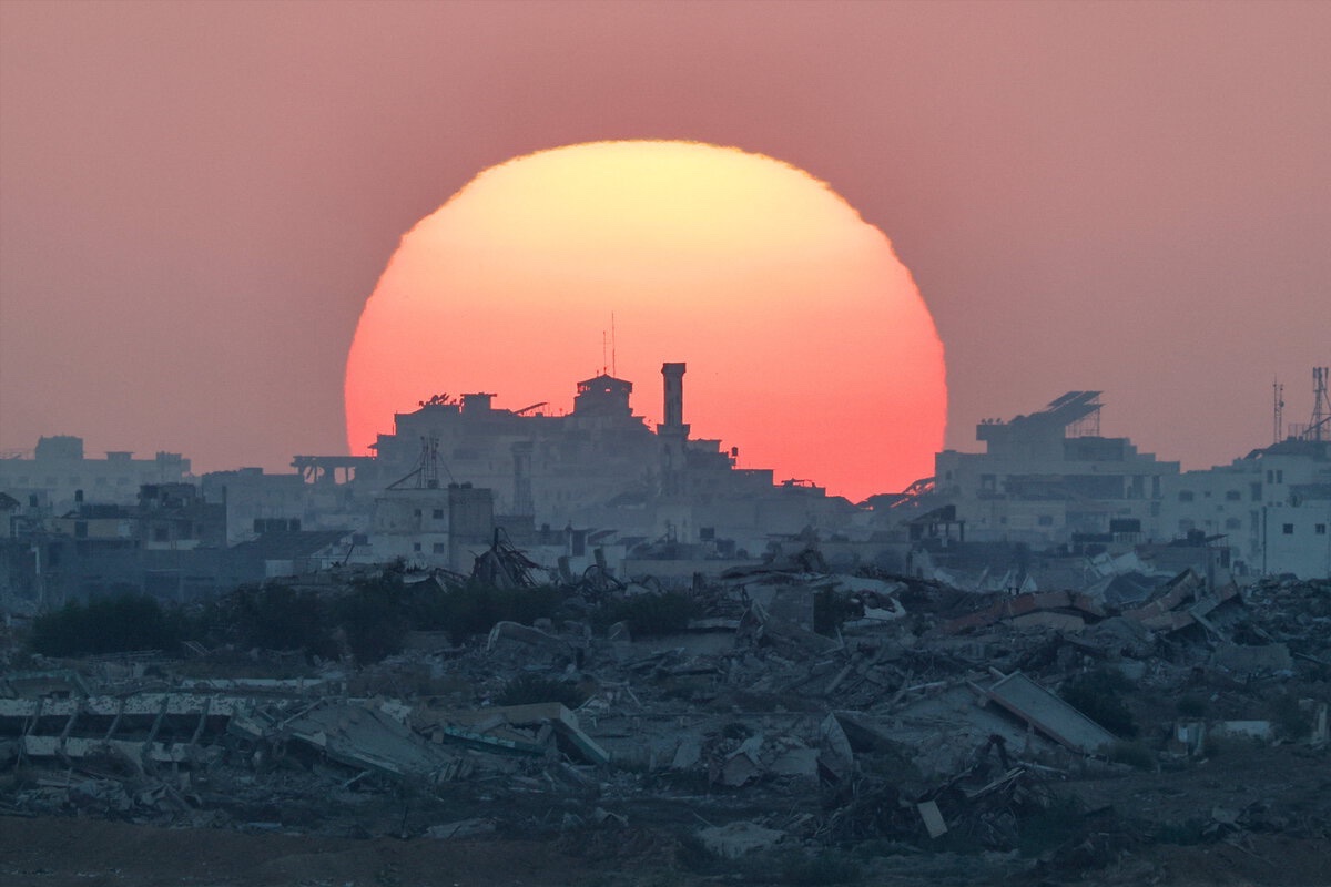 The sun sets over Gaza, as seen from the Israeli side of the border between Gaza and Israel, August 19, 2025.