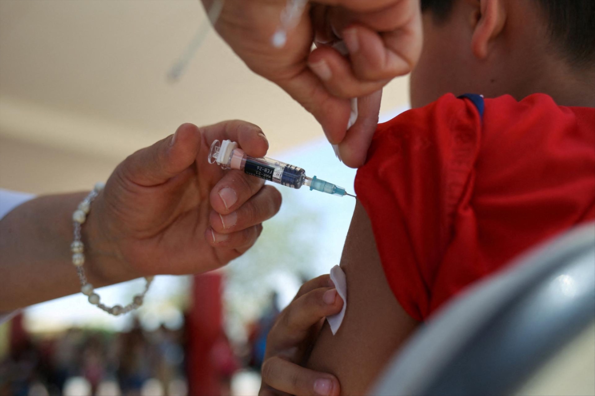 A health worker administers a dose of the measles vaccine to a child during a measles vaccination drive in Ciudad Juarez, Mexico, June 15, 2025.