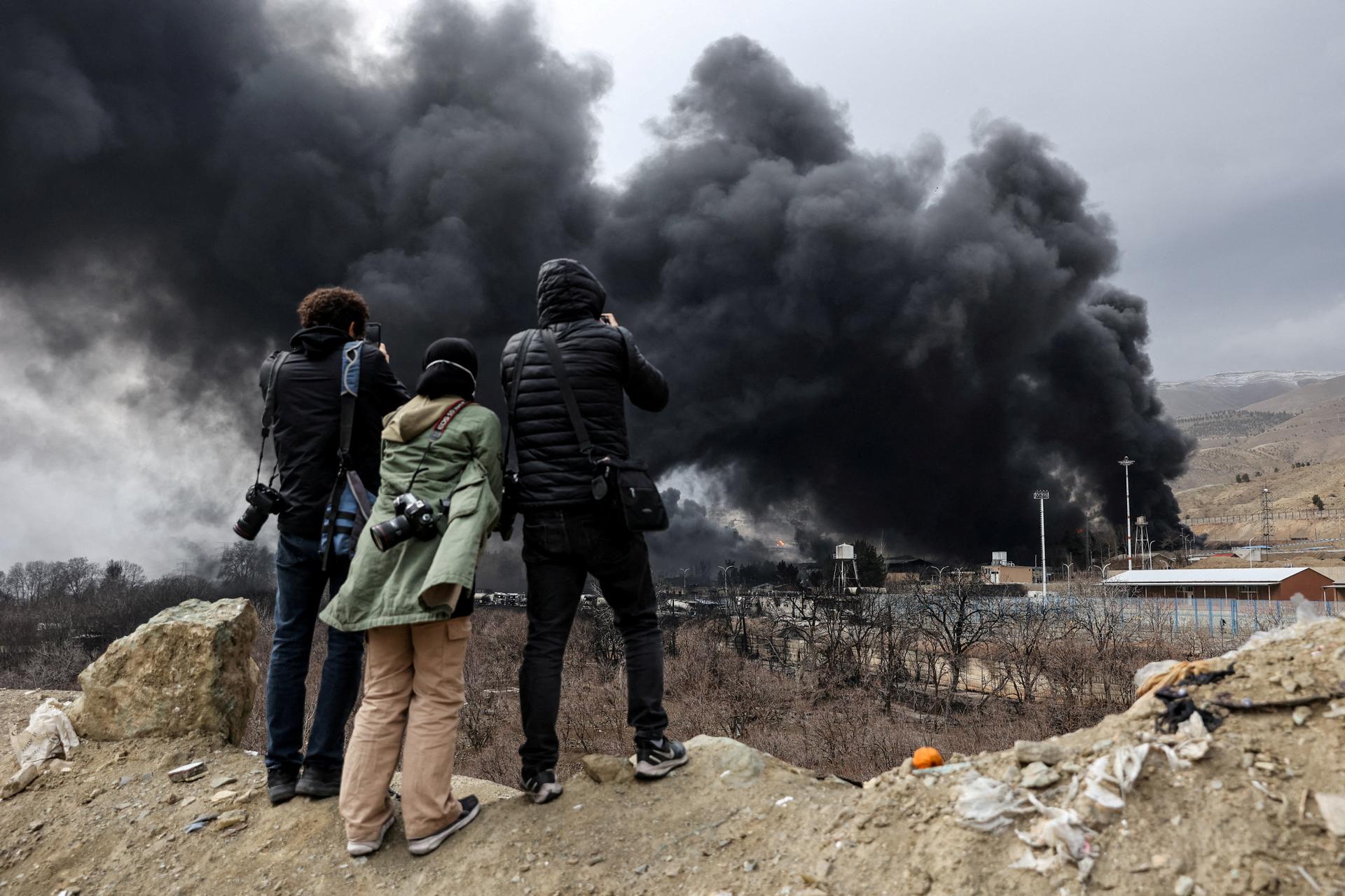 People record smoke rising after a reported strike on Shahran fuel tanks, in Tehran, Iran, on March 8, 2026. Majid Asgaripour/WANA (West Asia News Agency) via REUTERS