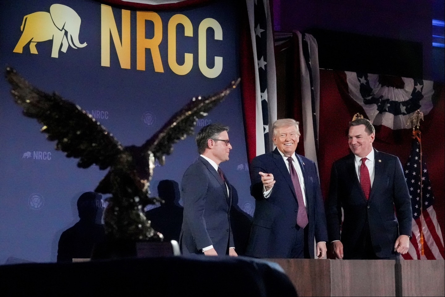 President Donald Trump, House Speaker Mike Johnson (R-LA), and Rep. Richard Hudson (R-NC), the chair of the National Republican Congressional Committee, at a fundraising dinner, March 25, 2026. 