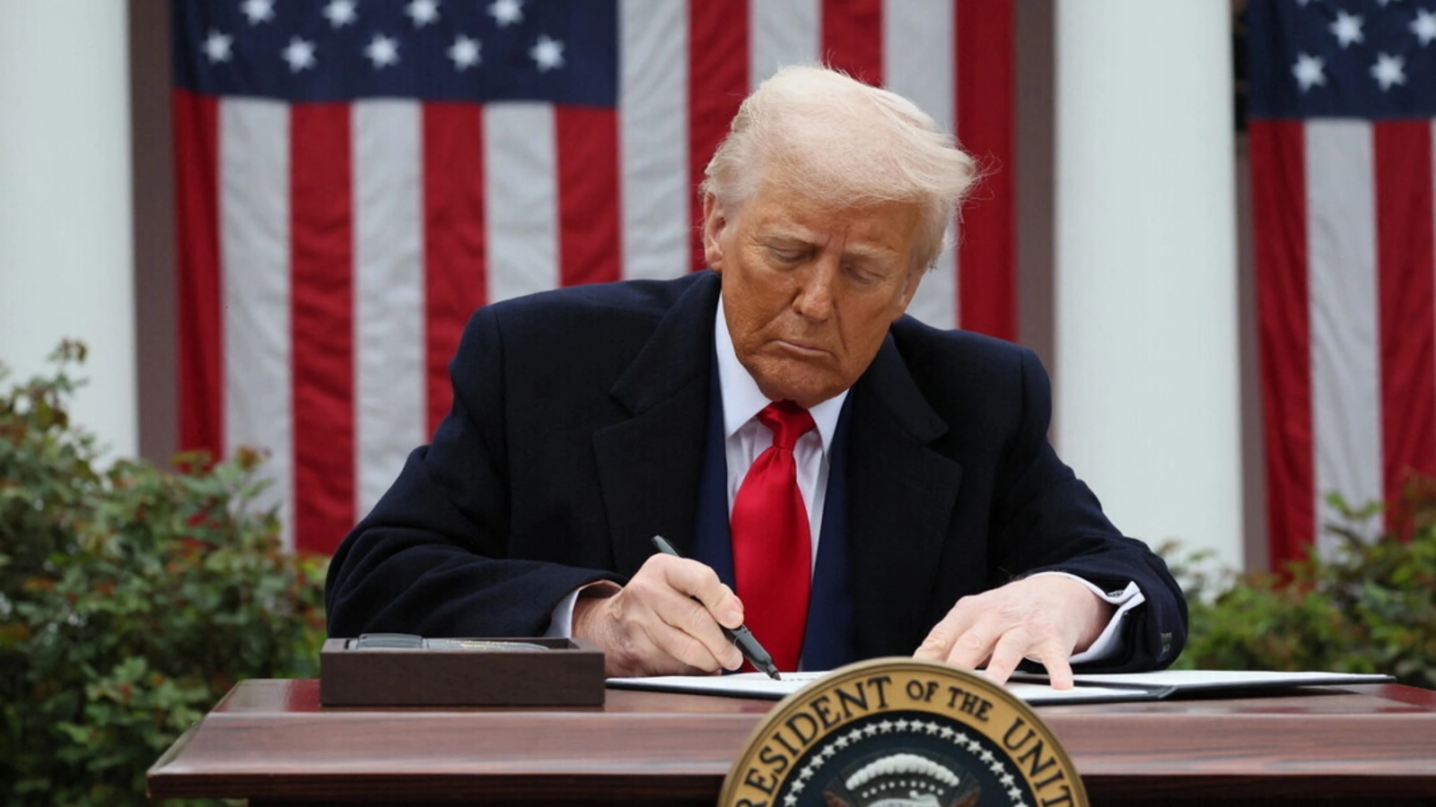 Donald Trump signs an executive order on tariffs, in the Rose Garden at the White House on April 2, 2025.