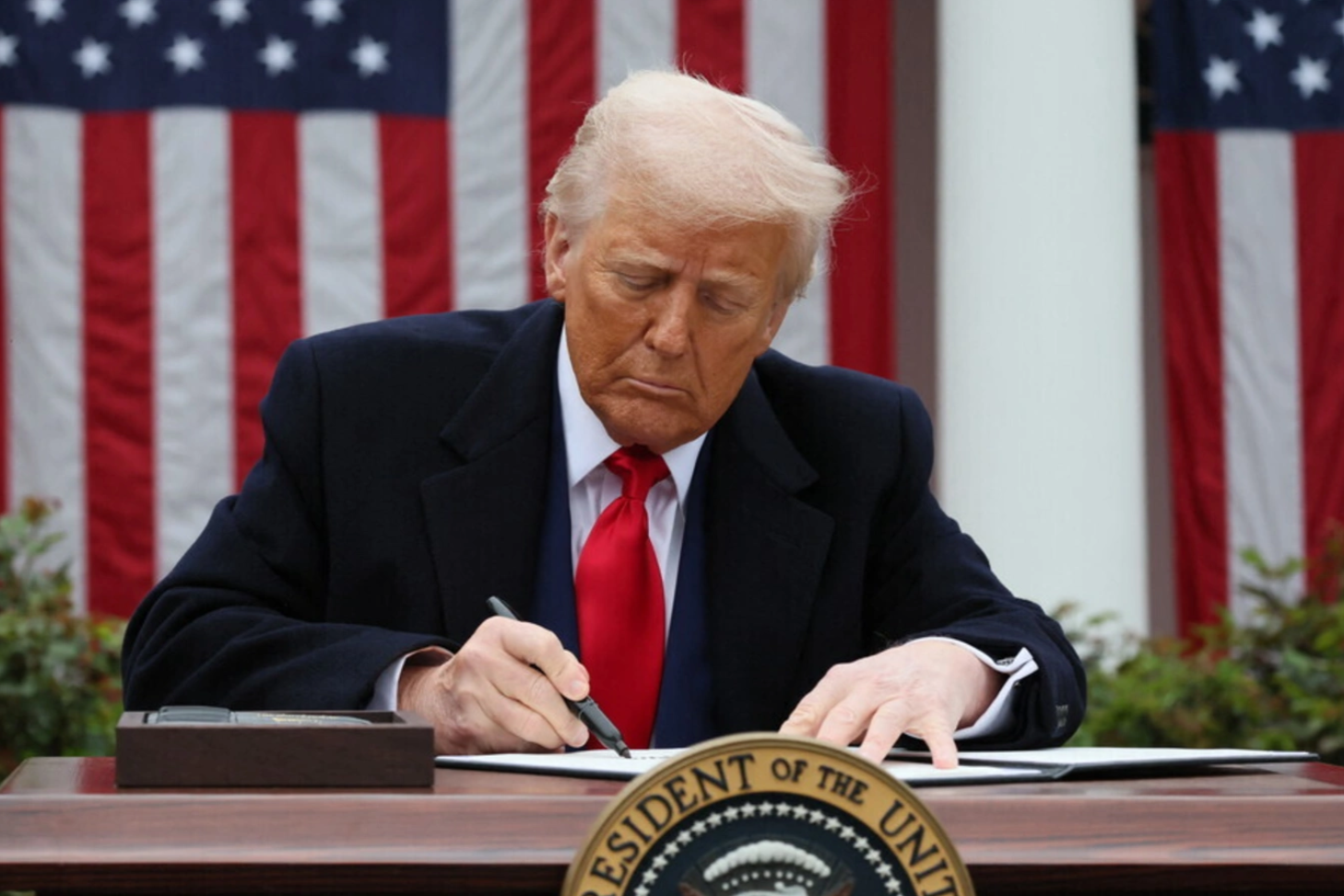 Donald Trump signs an executive order on tariffs, in the Rose Garden at the White House on April 2, 2025. Leah Millis/Reuters