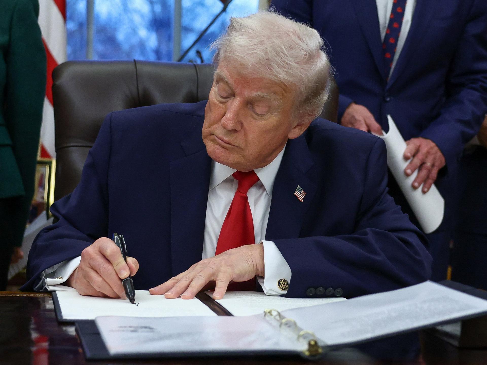 U.S. President Donald Trump signs an executive order for the 