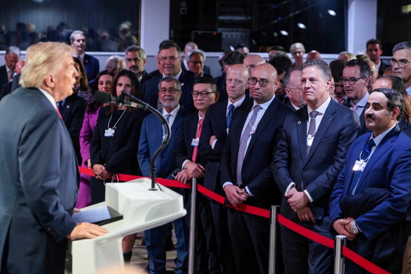 Attendees listen to President Donald Trump speaking during a reception with business leaders, at the 56th annual World Economic Forum (WEF), in Davos, Switzerland, on January 21, 2026.