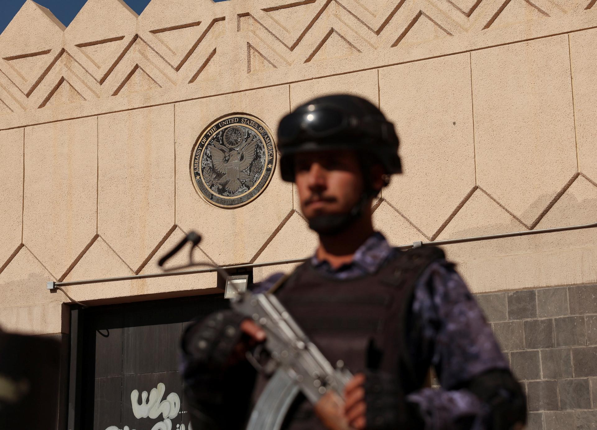 A member of the Houthis stands outside the U.S. Embassy in Sanaa, Yemen, during a rally on February 11, 2026, marking the tenth anniversary of the embassy’s closure and departure of U.S. Marines following the Houthi takeover. 