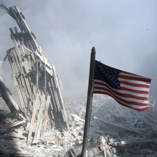 An American flag flies near the base of the destroyed World Trade Center