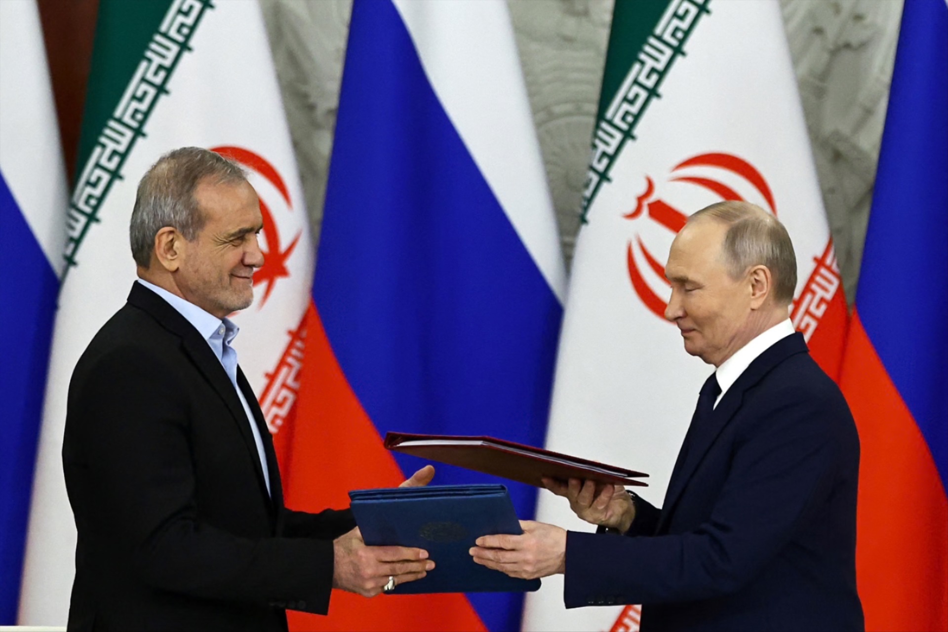Russian President Vladimir Putin and Iranian President Masoud Pezeshkian attend a documents signing ceremony in Moscow, Russia January 17, 2025.