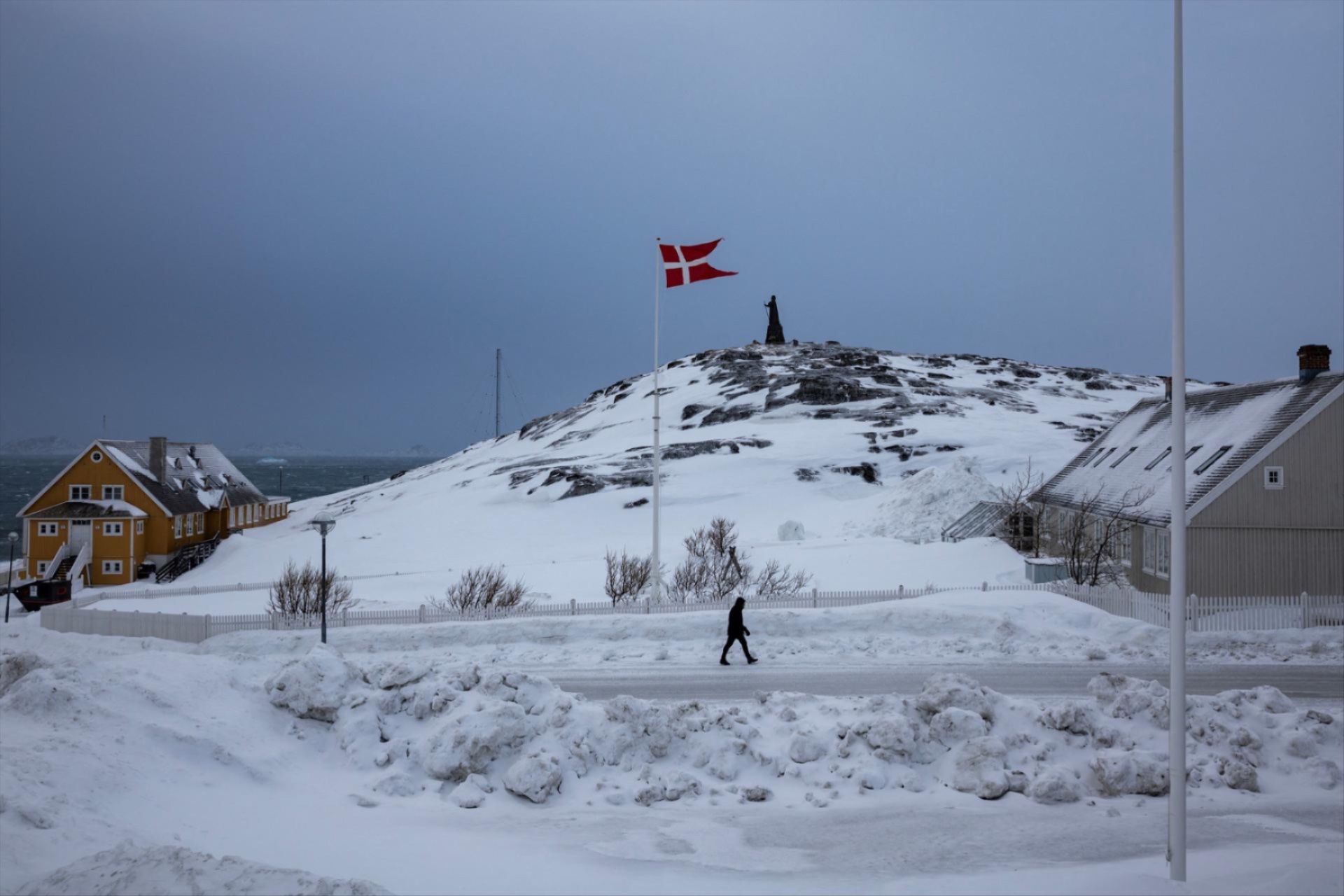 A man passes a Danish flag ahead of Greenland’s general election in the island’s capital, Nuuk.