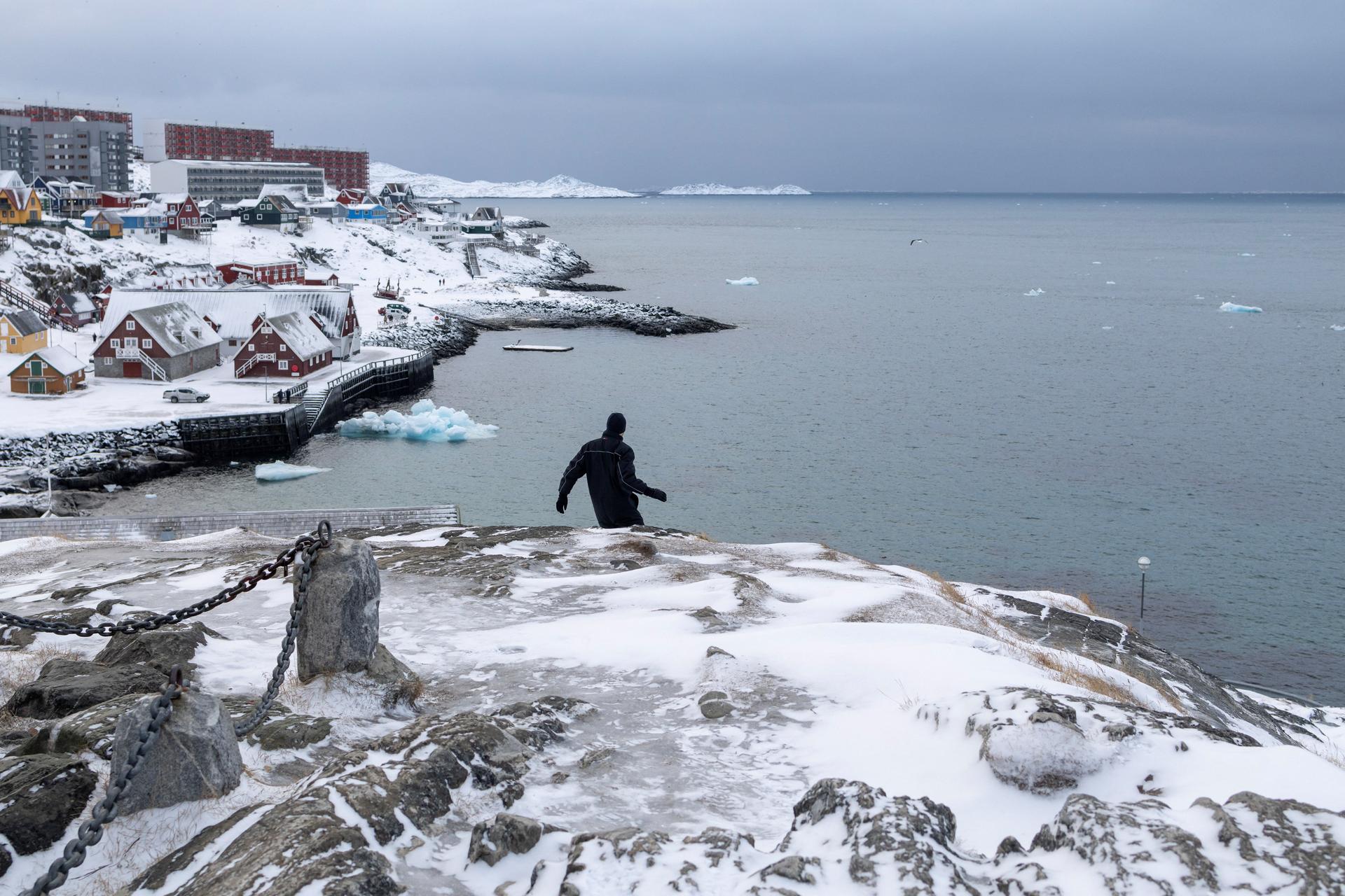 A man walks down the hill at Nuuk's old harbour, Greenland, January 18, 2026. REUTERS/Marko Djurica