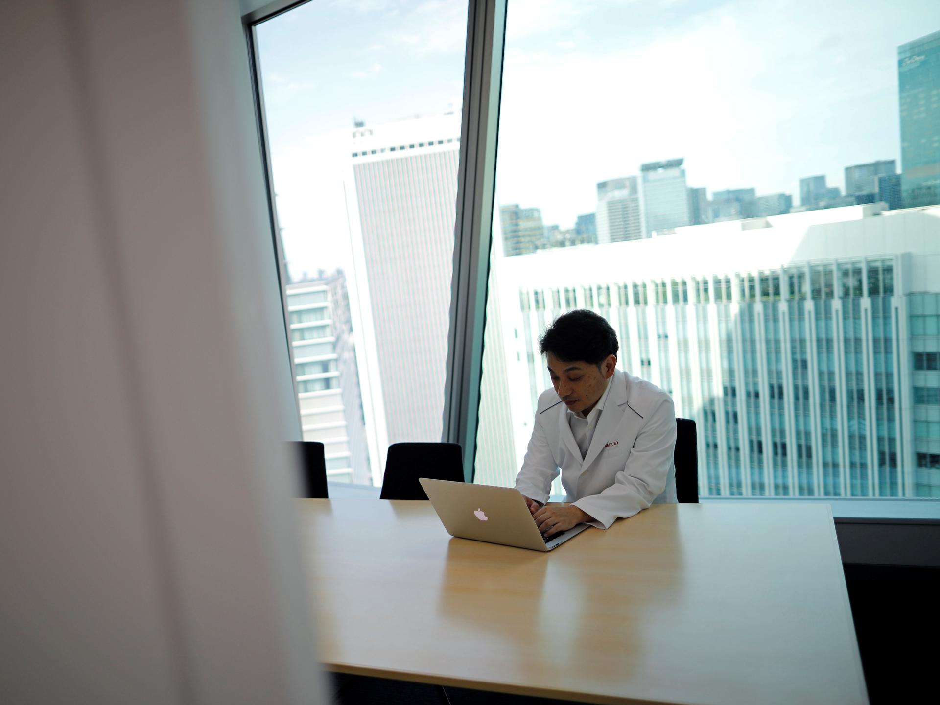 Makoto Kitada, MD, demonstrates a telemedicine application service called 'CLINICS,' in Tokyo, Japan, on July 8, 2020.