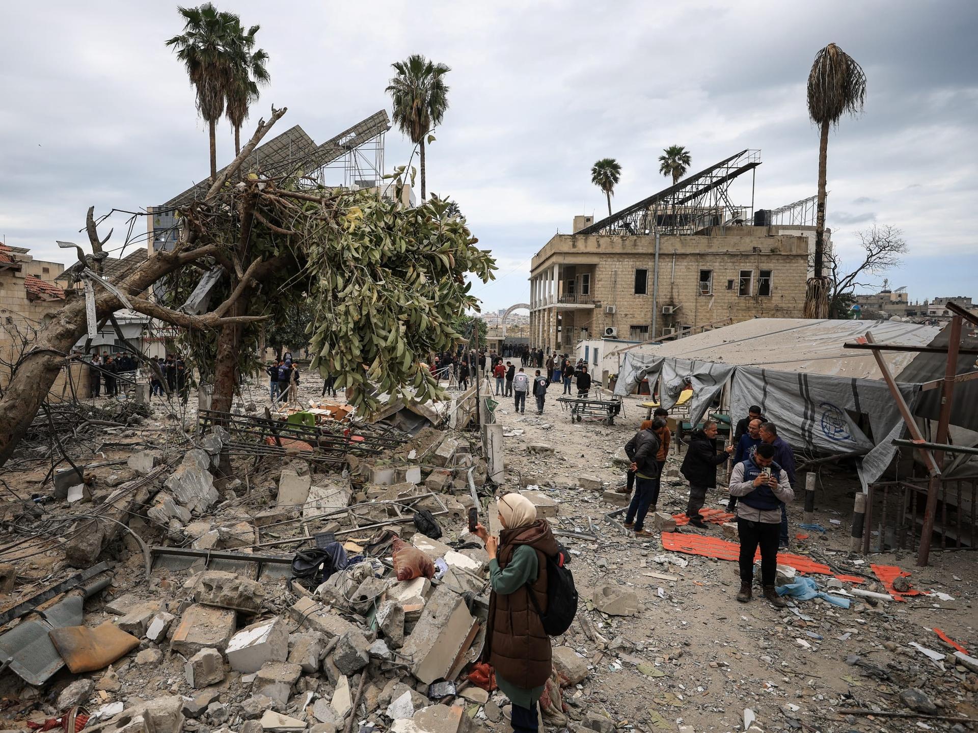 Palestinians inspect the damage after two Israeli missiles hit a building inside the Al-Ahli Arab Baptist Hospital, in the Gaza Strip, on April 13, 2025
