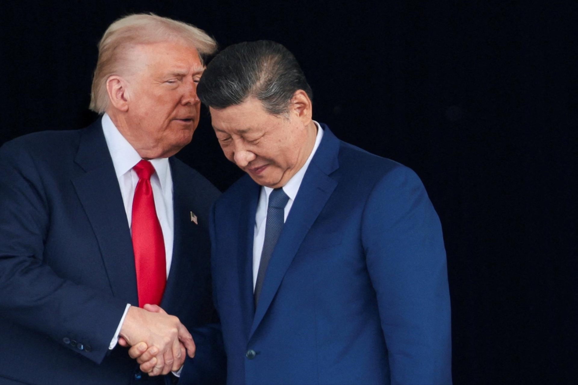 Donald Trump and Xi Jinping talk as they leave after a bilateral meeting in South Korea, October 30, 2025. 
