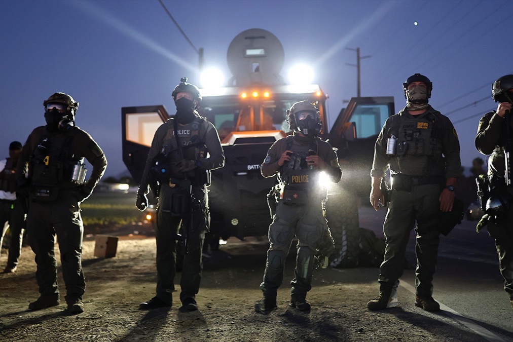 Federal agents block people protesting an ICE immigration raid at a licensed cannabis farm near Camarillo, California, July 10, 2025.