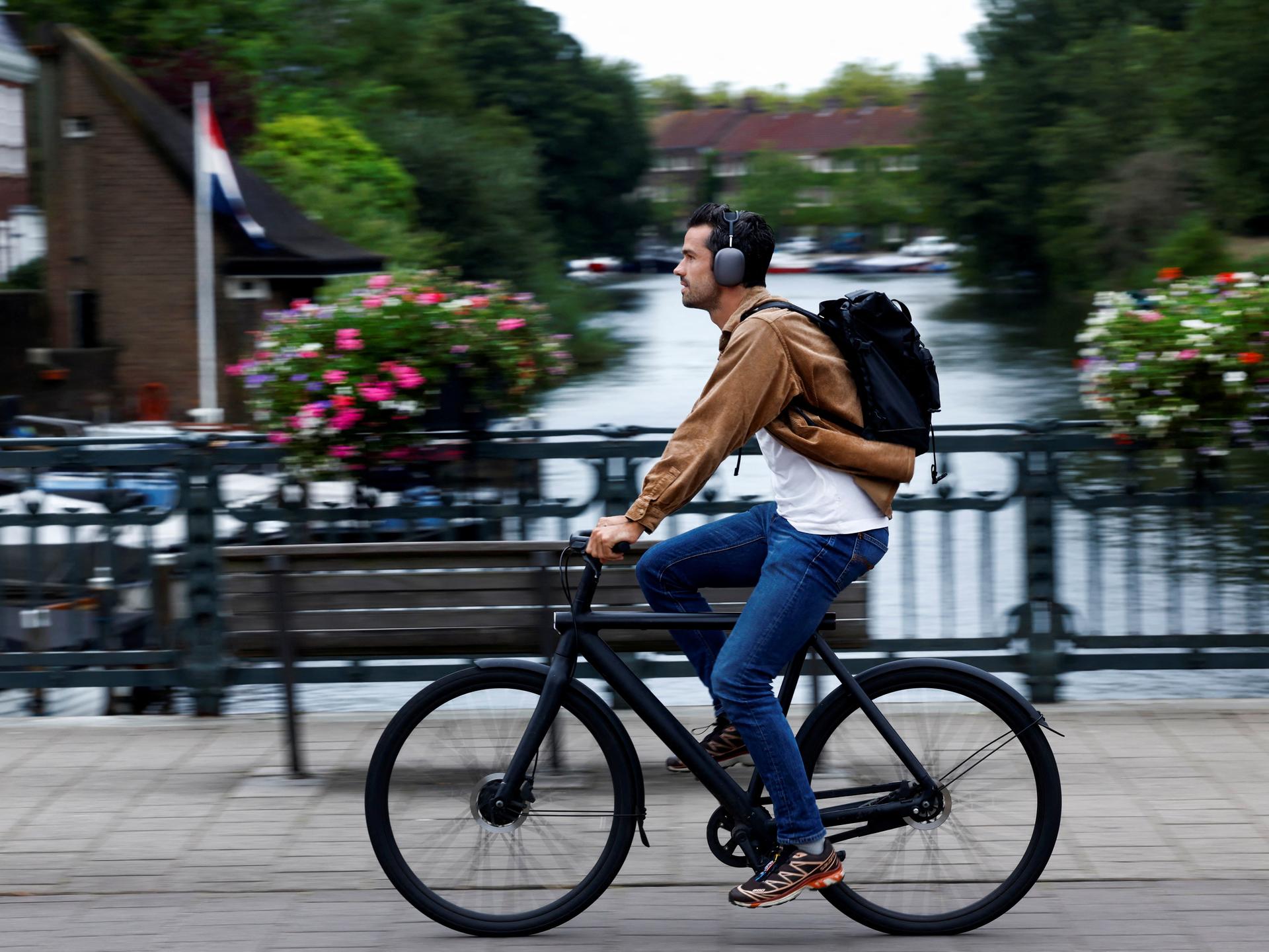 A man rides a VanMoof brand e-bike in Amsterdam, Netherlands, on August 17, 2023.