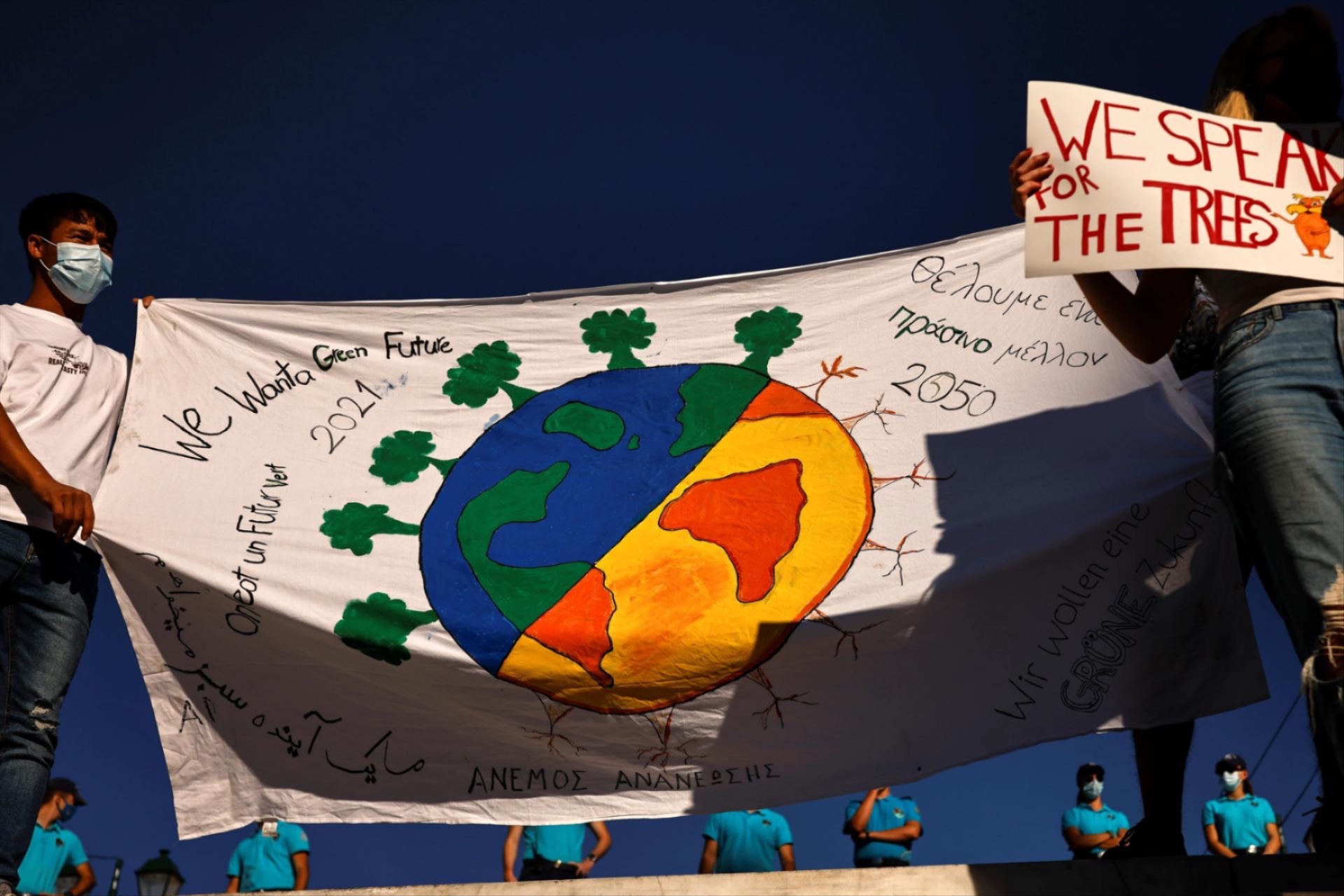 Greek students and activists of environmental organisations hold placards, as police stand guard during a Global Climate Strike rally of the movement Fridays for Future, in Athens, Greece.