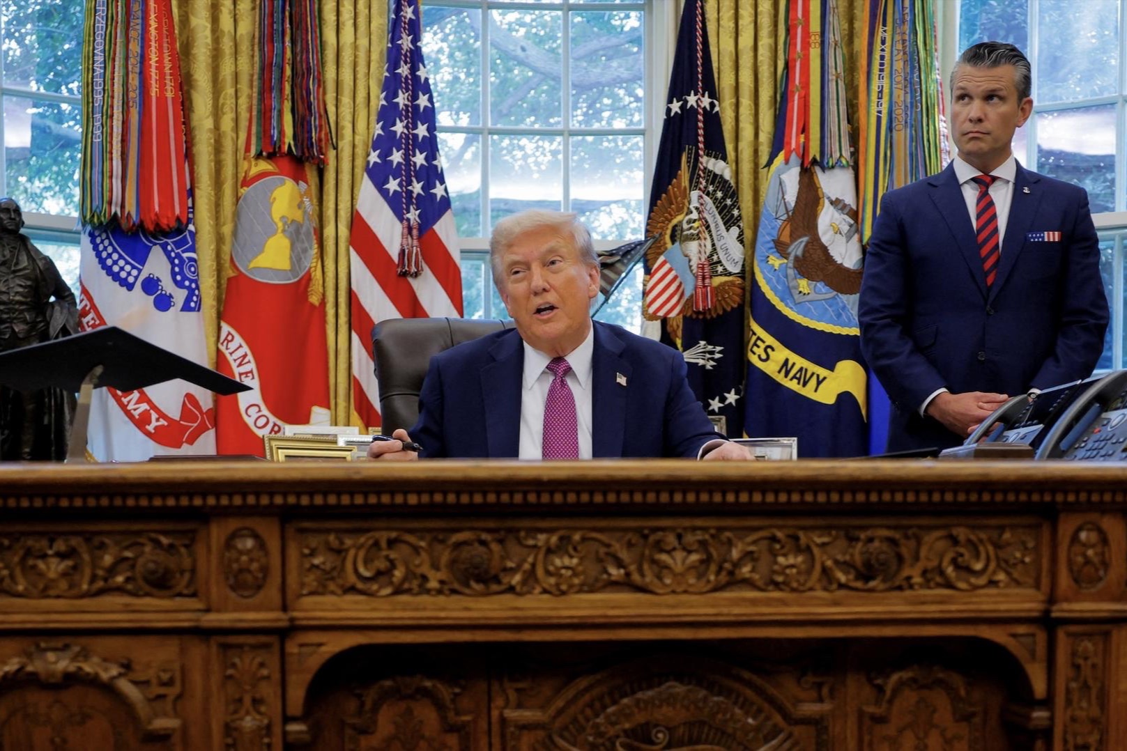 U.S. President Donald Trump, accompanied by U.S. Defense Secretary Pete Hegseth, speaks with the media while signing an executive order in the Oval Office, at the White House in Washington, D.C., on September 5.