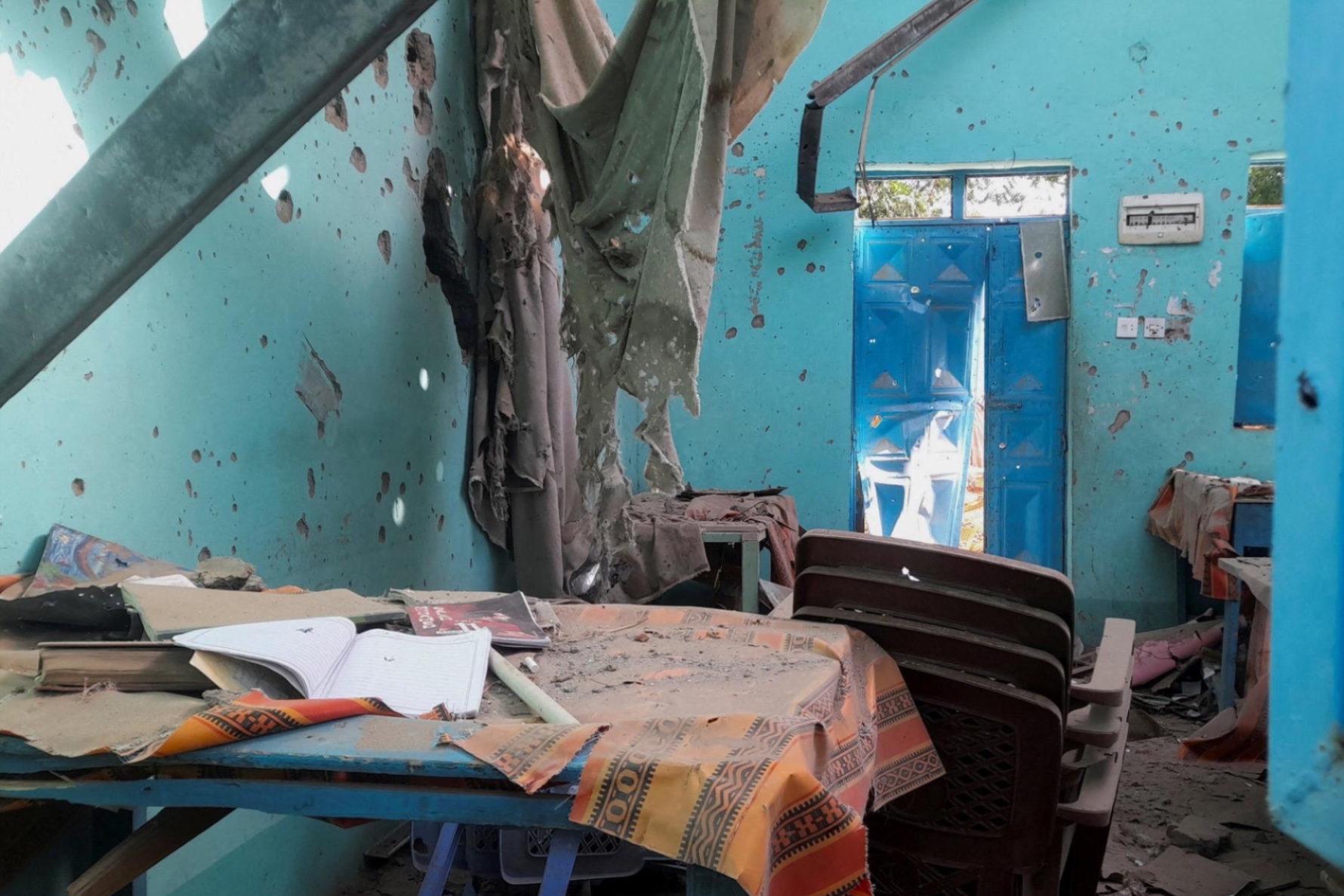 A desk bearing signs of shelling in a school where displaced people are sheltering, in El Fasher, Sudan, October 7, 2025