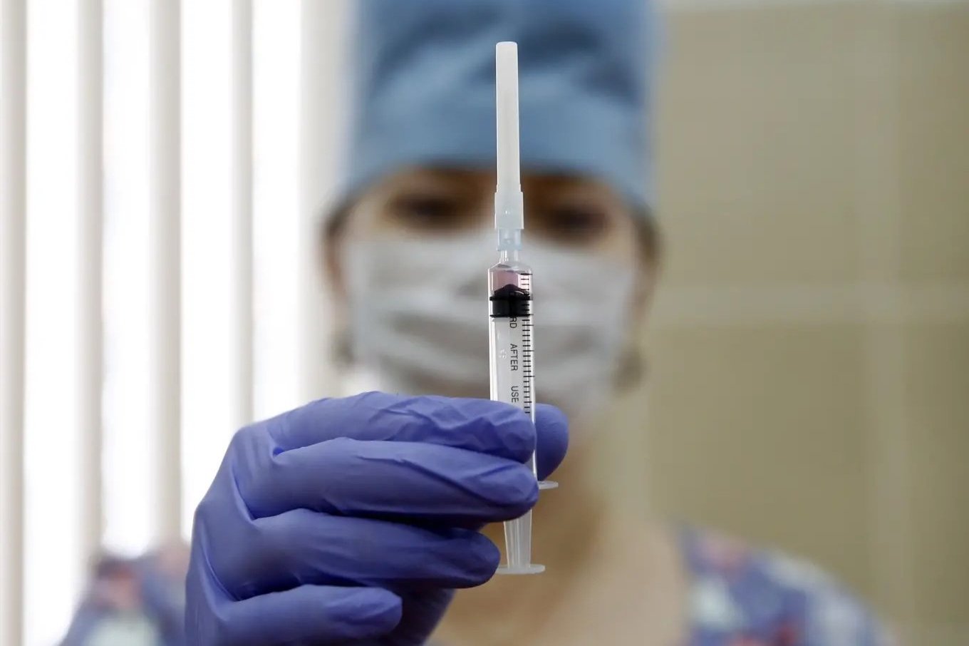 A medical staff worker with a syringe containing vaccine for measles and mumps at a clinic in Moscow, Russia.