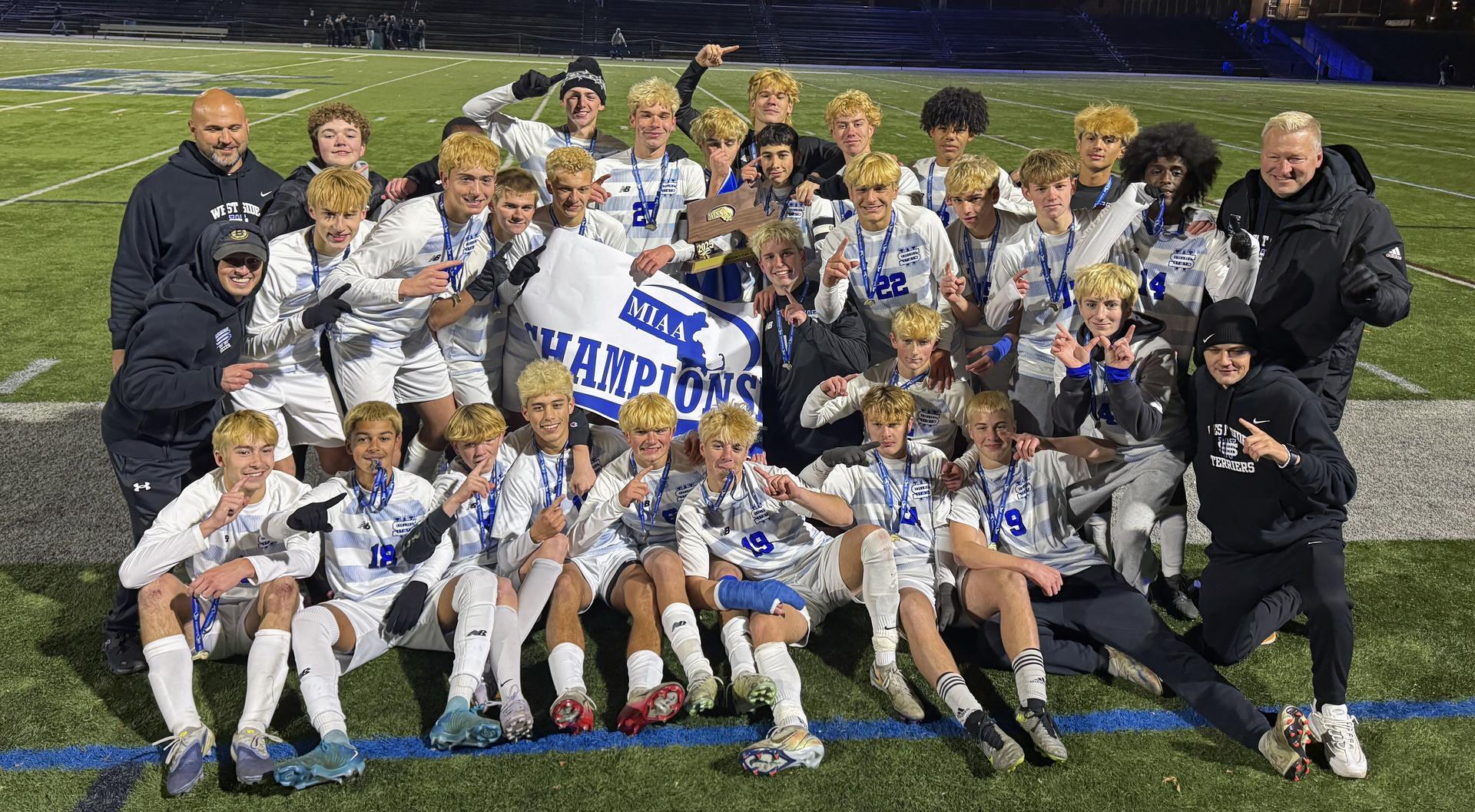 Kayakers on the water pass a rock formation