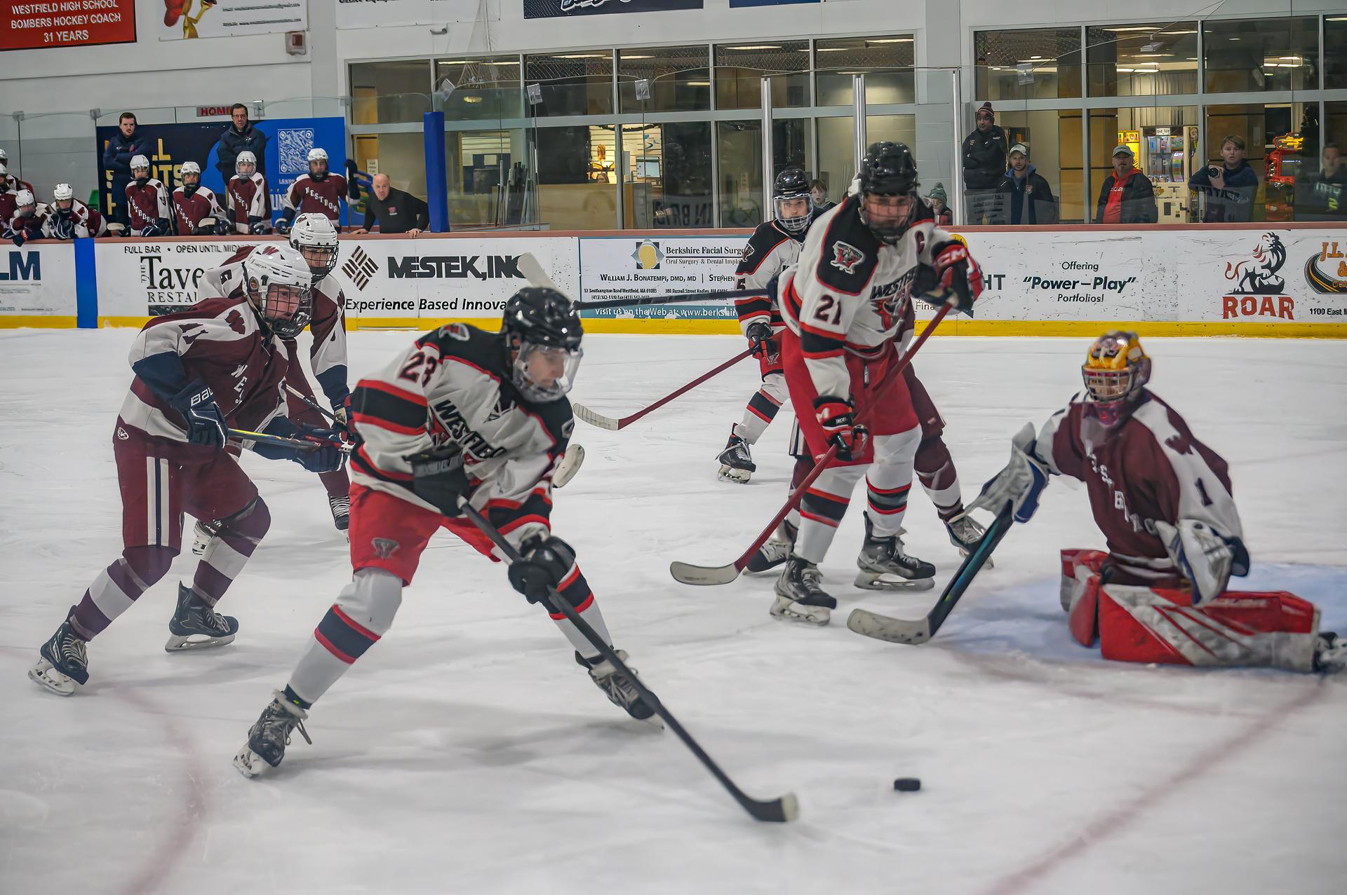 Kayakers on the water pass a rock formation