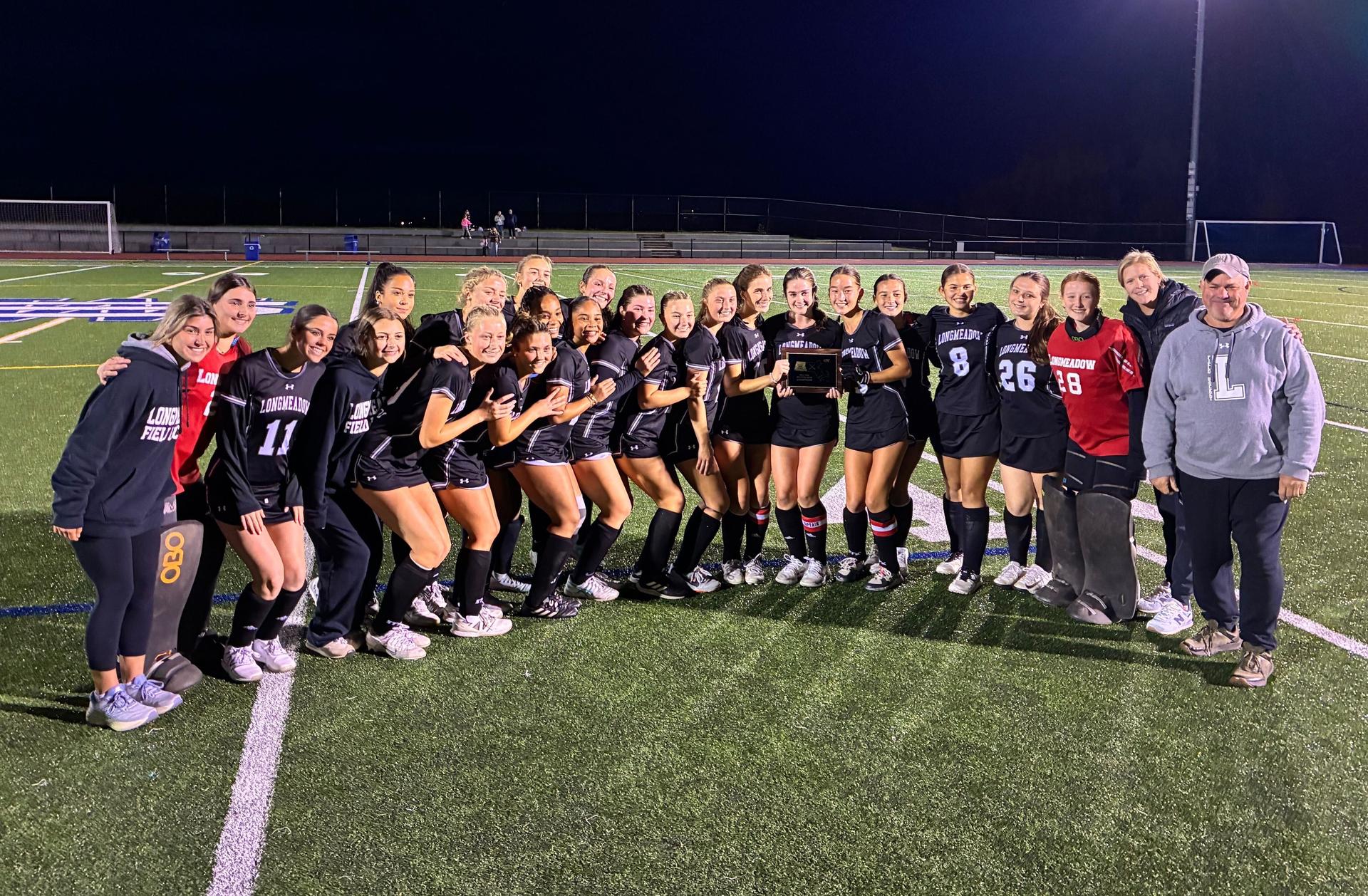 Kayakers on the water pass a rock formation