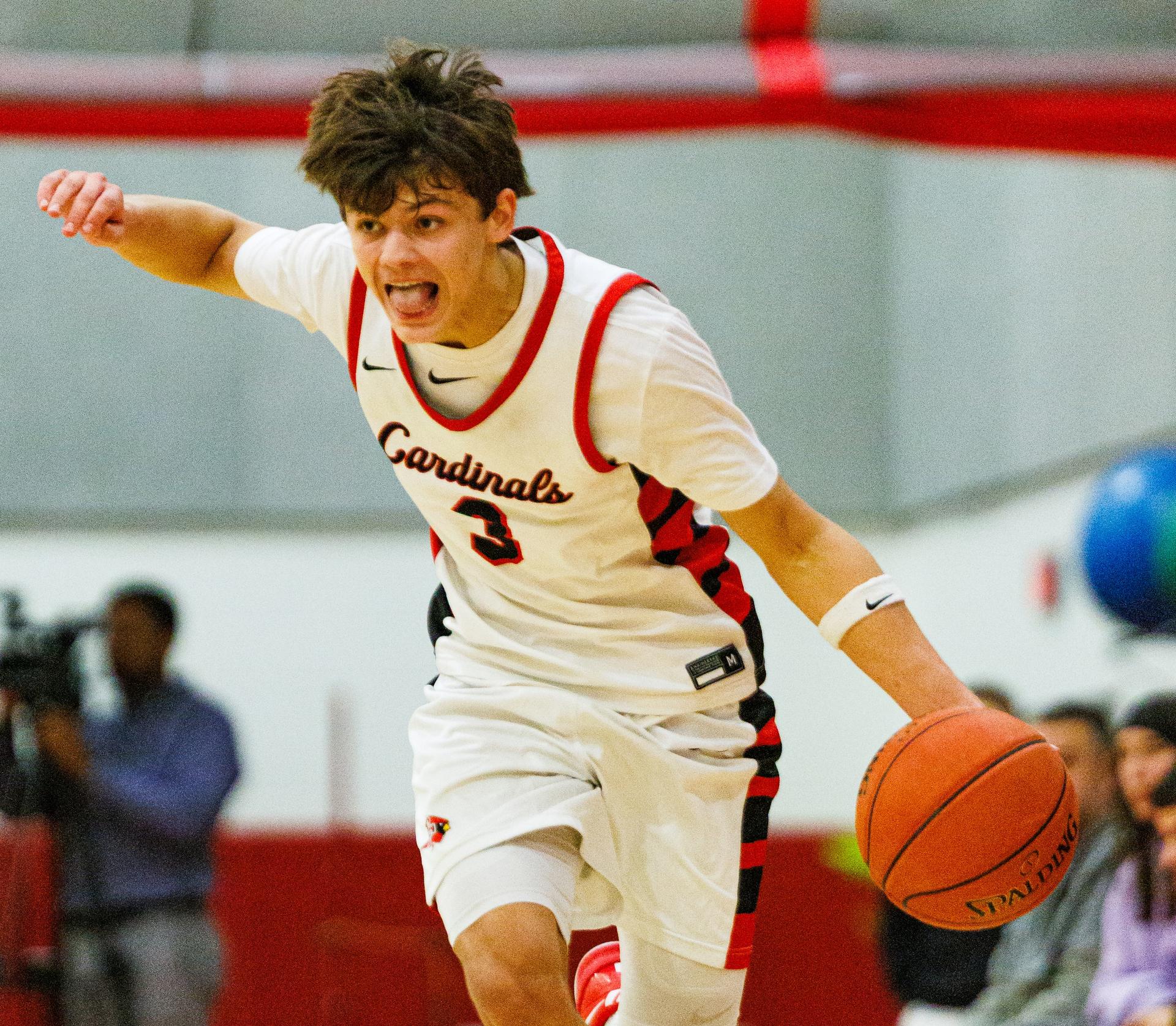 Kayakers on the water pass a rock formation