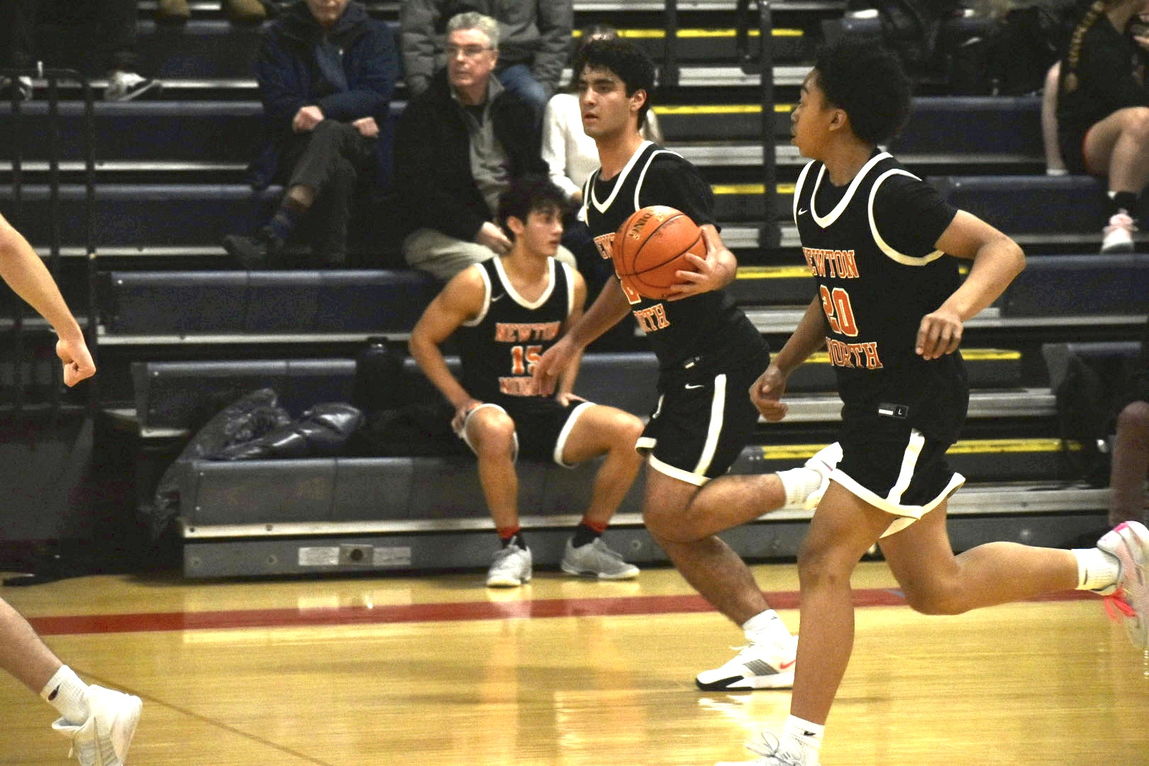 Kayakers on the water pass a rock formation